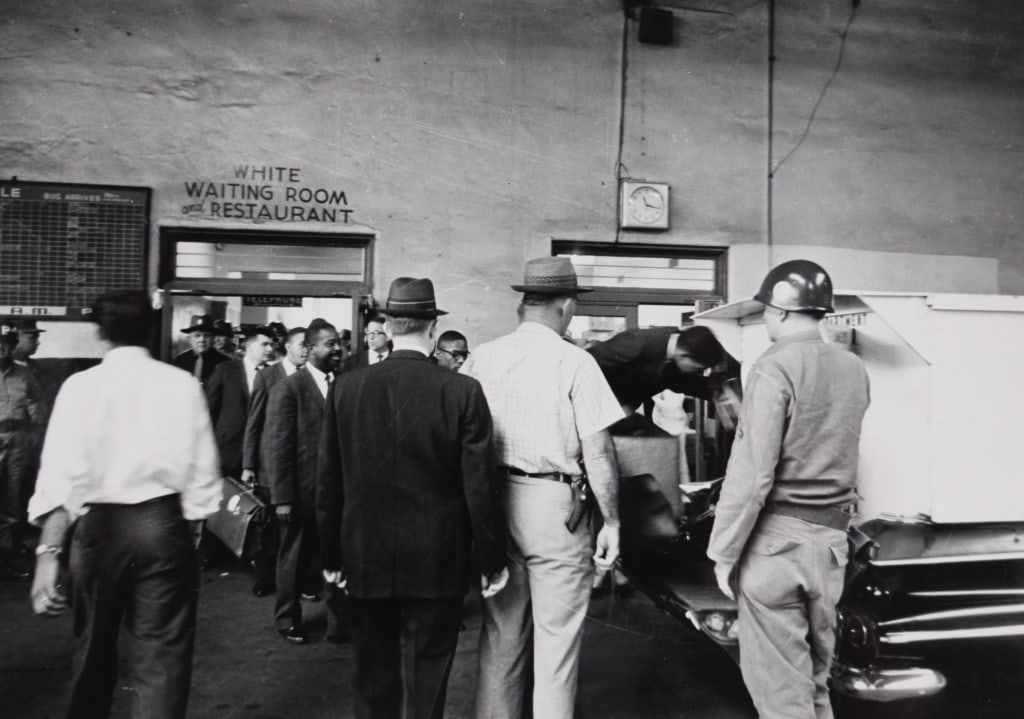 BETTMANN, OTTO. WHITE WAITING ROOM. ALABAMA. 1961: BETTMANN, Otto. WHITE WAITING ROOM AND RESTAURANT. MONTGOMERY, ALABAMA. 1961. Silver print mounted with plastic corners in mat. Verso titled and dated, with UPI/Bettmann Newsphotos label. Print: 6.5"
