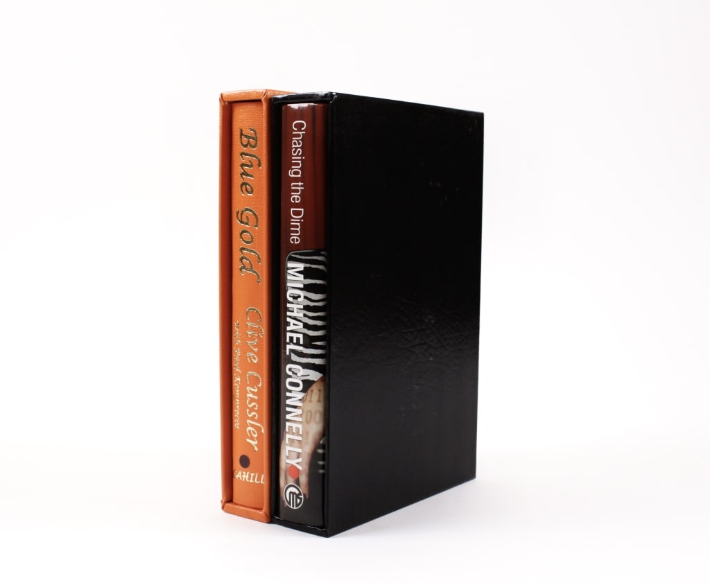 [LIMITED EDITION LITERATURE] LOT OF 2 VOLUMES: LIMITED EDITION LITERATURE. A lot of 2 volumes sold together. Both 8vo, paper and cloth boards, slipcases. Including: Cussler, Clive; Kemprecos, Paul. BLUE GOLD. A NOVEL FROM THE NUMA FILES. New York: