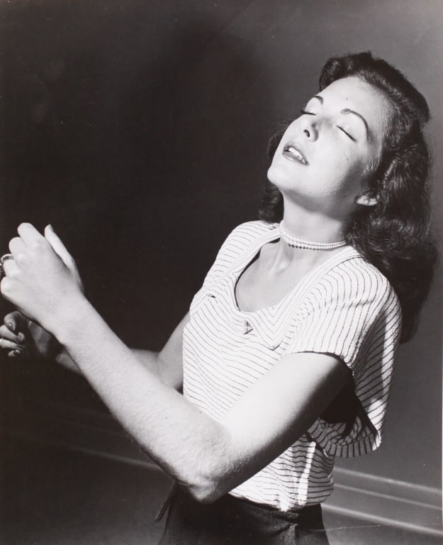 HALSMAN. HOLLYWOOD STARLETS: CATHY DOWNS. 1949: HALSMAN, Philippe. HOLLYWOOD. CATHY DOWNS. 1949. Silver print. Halsman's backstamp, title and date penciled on verso. 13.5" x 10.75". Generally very good condition, various imperfections: crease at lo
