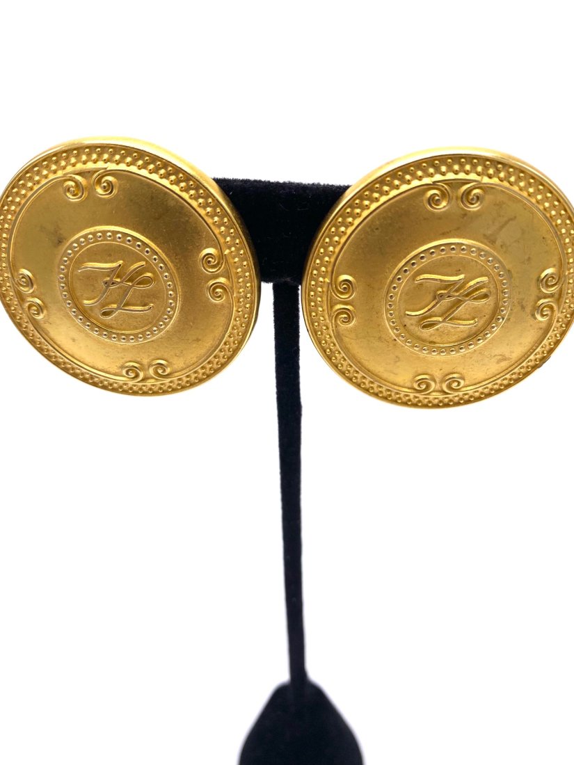 Large Karl Lagerfeld Disk Clip on Earrings: A great and hard to find pair of Karl Lagerfeld Clip on earrings. Not easy to find these days. Great to match with other KL items with matching logo. This sale is online only-no public preview or live
