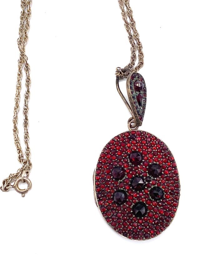 Gorgeous Large Garnet Mourning Pendant Necklace: This could be a picture locket or hair locket. The glass is loose needs a bit of glue. It seems very early to me. Tested Sterling with gold wash. Necklace Measures 24" and pendant is just a little ove