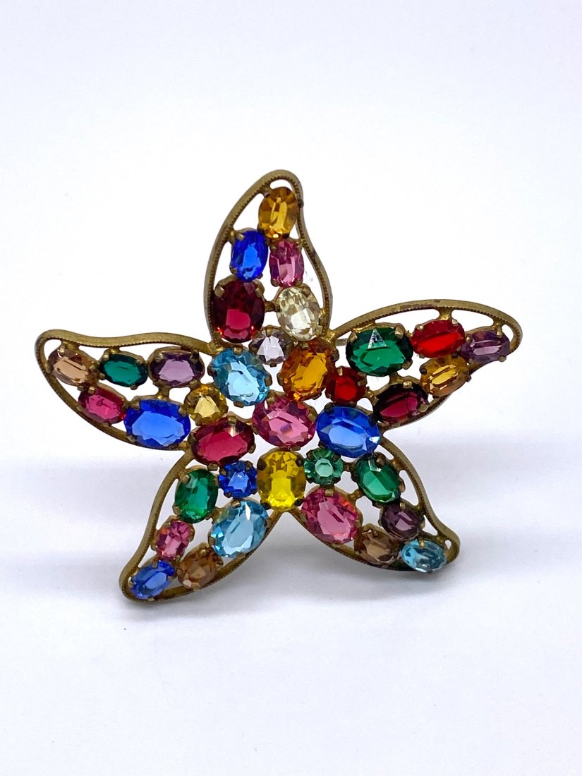 Beautiful Czechoslovakian Star Pin: This 1920s Czechoslovakian multicolor stone pin is quite beautiful. Normal condition for its age. All stones are present. For the Czechoslovakian glass collector this is a great addition. Measures 2 1