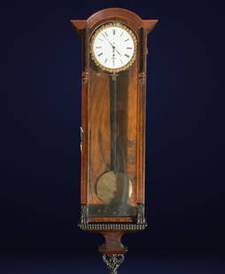 Wall clock. German School. 19th century: Carved wood, glass, and enameled dial. Dimensions: 90 x 30 x 13 cm. Wall pendulum clock with a mahogany-finished wooden case topped with a curved pediment. The white dial with Roman numerals is framed