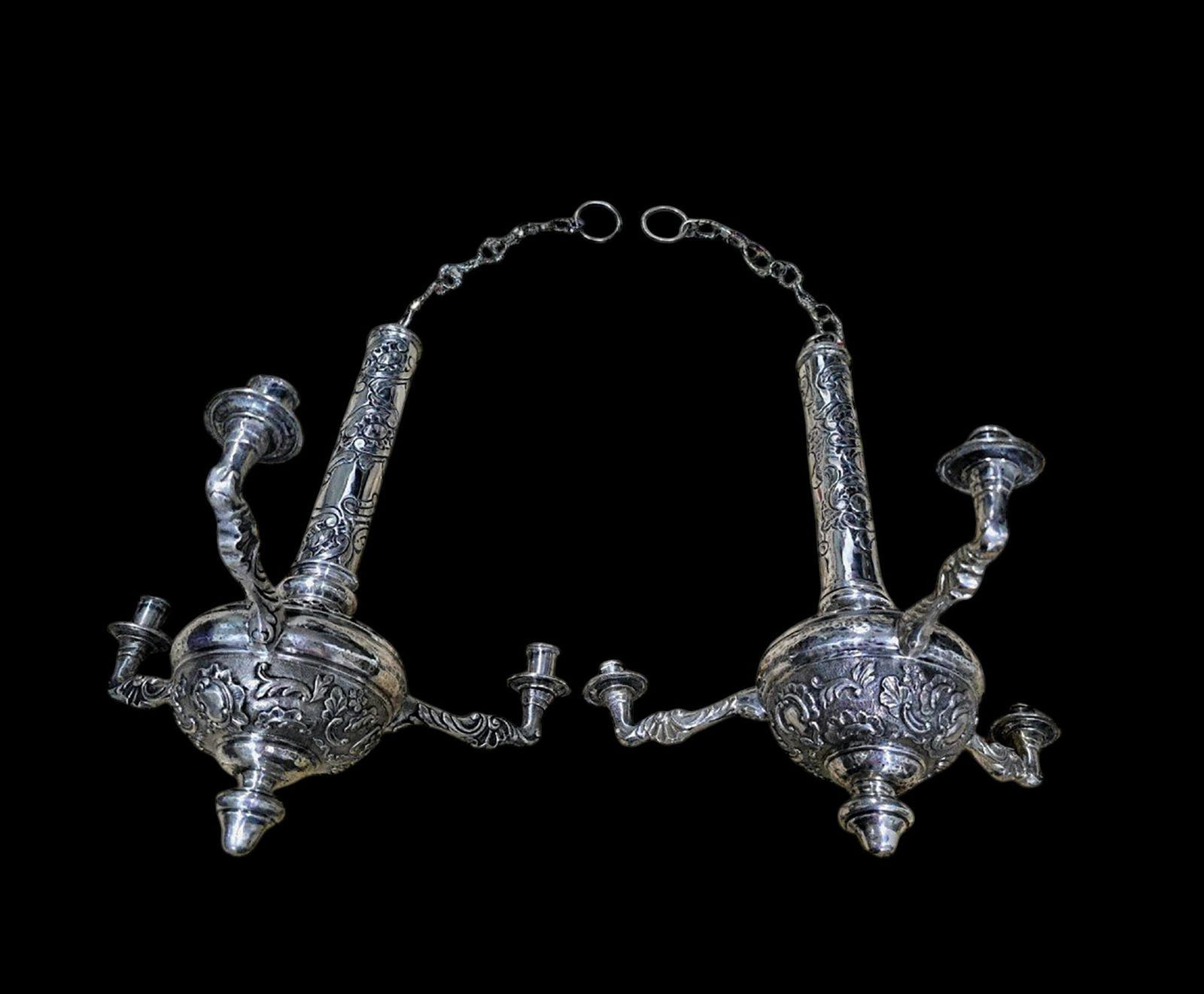 Pair of solid silver candlesticks, Spain, 18th century: Solid embossed silver. Measurements: Without chain: 40 x 35 x 35 cm Chain length: 21 cm (also in solid silver).