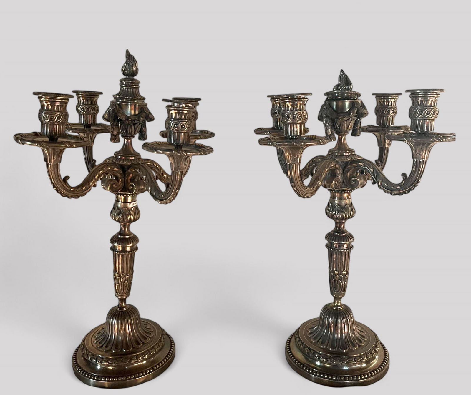 Pair of silver-plated bronze Louis XVI style candlesticks. 53x34x34cm.: 4-armed, decorated with fluting and laurel wreath, Louis XVI style. 53x34x34cm.
