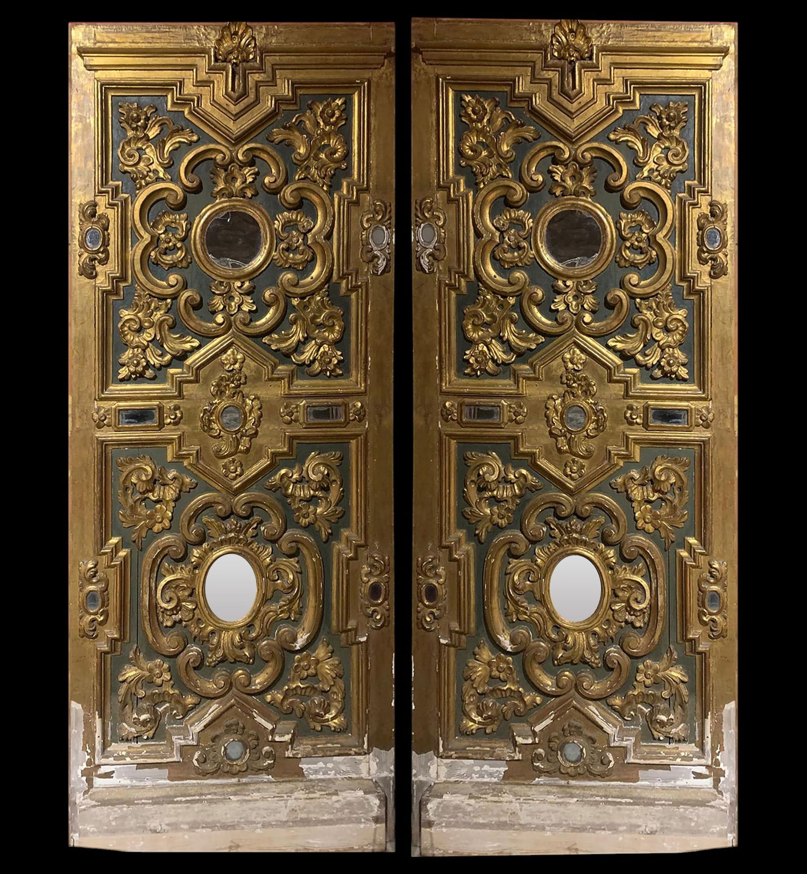 Pair of Massive 17th C Palazzo Doors, Italian, Venice: With profuse ornamentation and sculptural mastery characteristic of Baroque splendor, these sacristy doors feature a richly carved structure, with an interplay of volutes, scrolls, and plant motifs fr