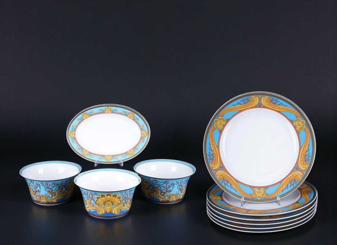 Les Trésors de la Mer by Versace for Rosenthal. German School. 20th century: Glazed and decorated porcelain. Measurements: bowls H 10.5 cm x D 20 cm, platter L 28 cm x W 20.5 cm, plates D 27 cm. This set comprises three bowls, one oval platter, and six dinner plates from the c