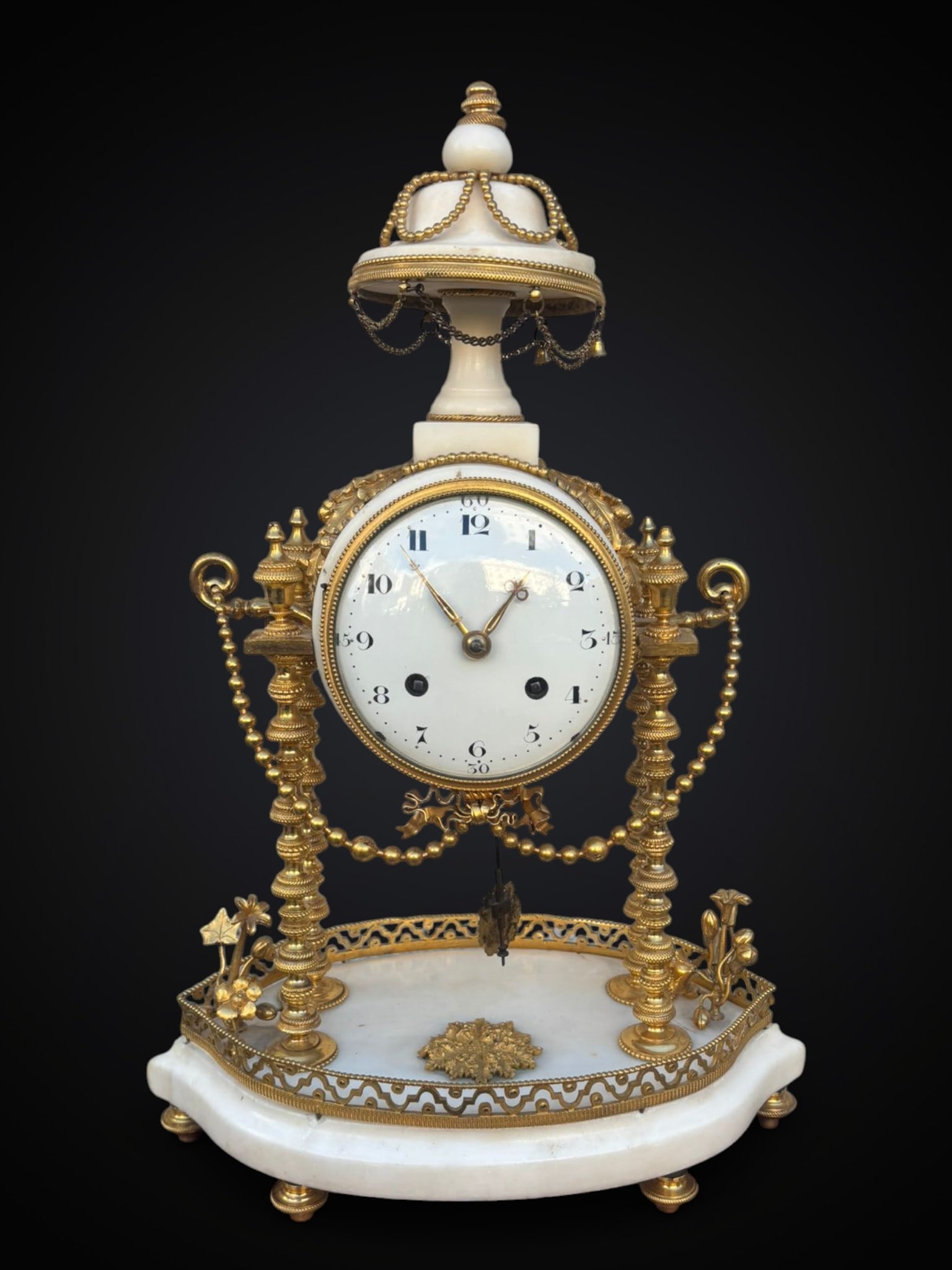 French Louis XVI clock, period and style of the 18th century: In white Carrara marble and Ormolu bronzes, 42 cm high