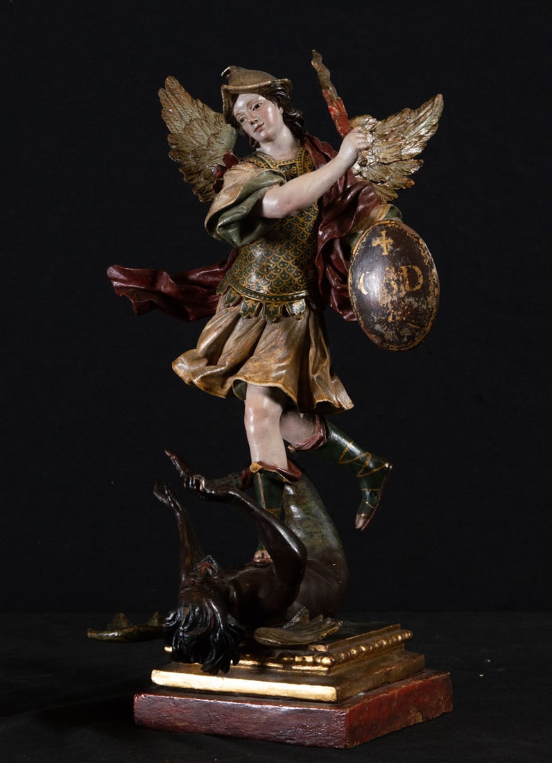 Very important Archangel Saint Michael subduing the Devil, Colonial school of Quito from the 18th: In carved, gilded, polychrome and sgraffito wood, in good condition, with the emblem "Who Like God?" engraved in initials on his shield. Measurements: 37 x 21 x 24 cm. Property of a Spanish Collector.