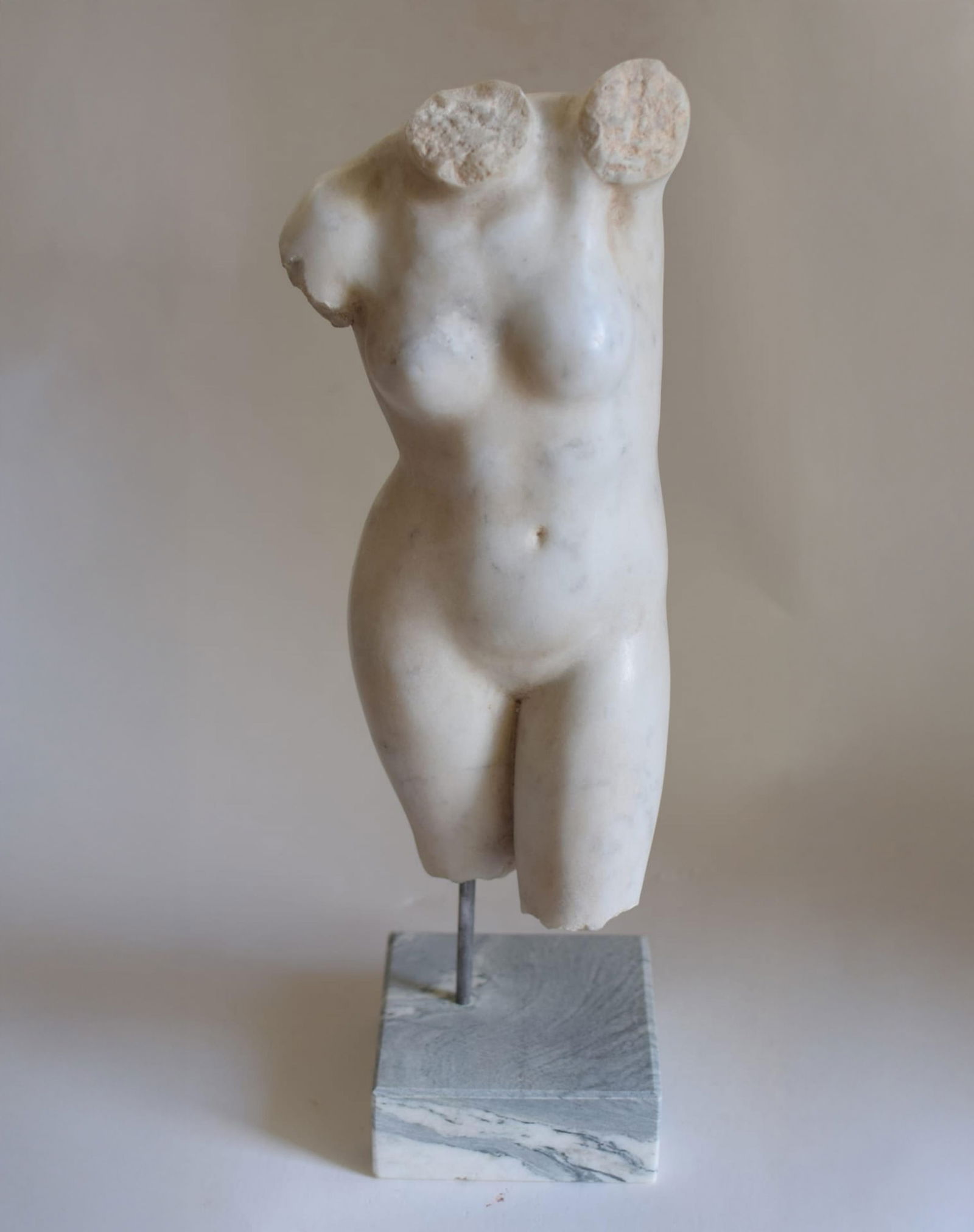 Highly decorative female torso in Carrara marble - Italian school. 20th century.: Carved in Carrara marble with formal purity and classical balance. Dimensions: 43 cm high. This sculpture represents a nude female torso, devoid of head, arms, and part of the legs, in a format that e