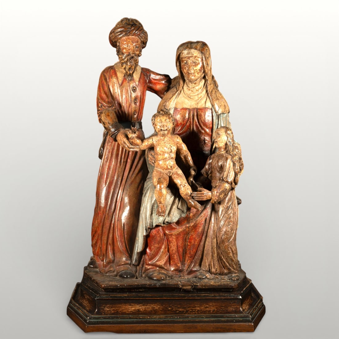 Holy Family, religious sculpture, 16th century: Polychrome wood. Dimensions: 86 cm x 56 cm x 34 cm. Sculptural group of the Holy Family composed of Saint Joseph, standing, wearing a turban and long tunic, next to Saint Anne, seated, who holds the f