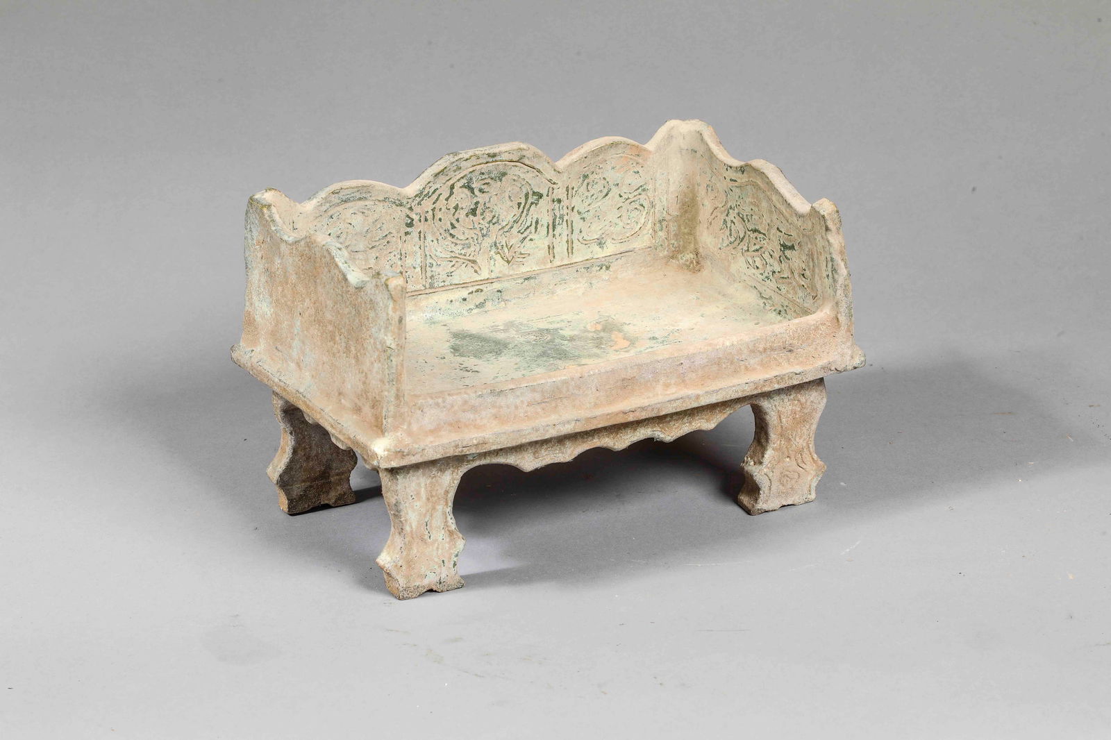 Mingqi funerary offering in the form of a bed, China, Ming Dynasty, 14th - 17th century: Terracotta with beige slip and green glaze. Dimensions not indicated. A Mingqi funerary offering designed to symbolize the household furnishings intended to accompany the deceased in the afterlife. Th