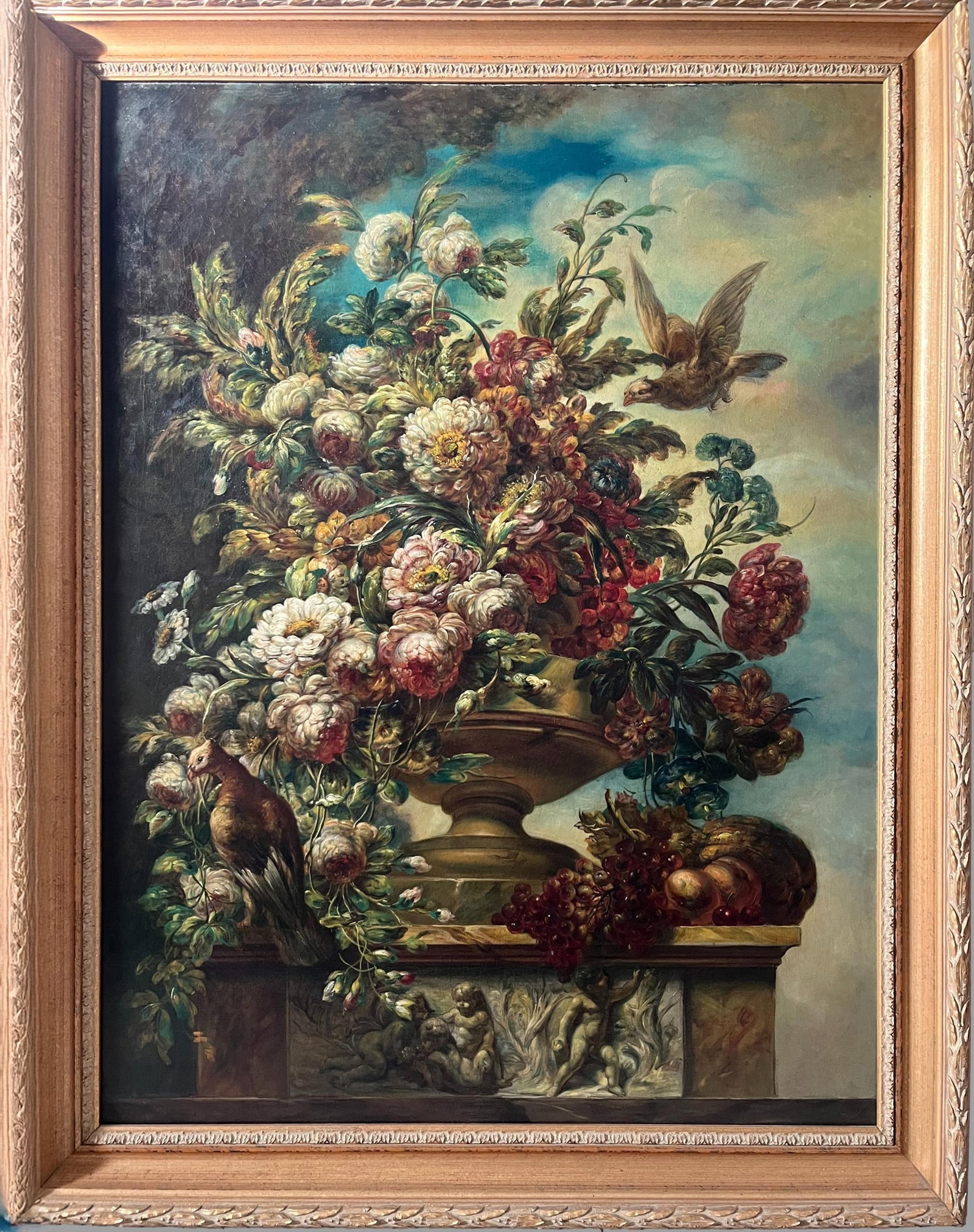Floral composition with pheasant, French School, 19th century: Oil on relined canvas. Dimensions 125 x 95 cm. A large floral composition arranged in a classically inspired vase resting on a sculpted marble base with cherubs, where an exuberant display of flowers