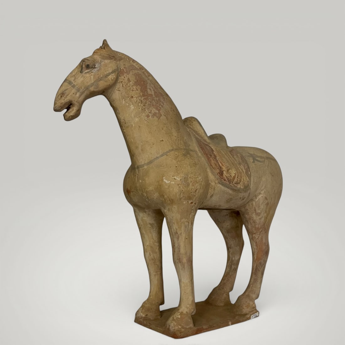 Tang funerary horse, Tang Dynasty, 7th - 10th century: Modeled and polychromed terracotta sculpture. Dimensions not indicated. Funerary figure depicting a horse in a static pose, its body rendered in a naturalistic and proportionate manner, resting on an