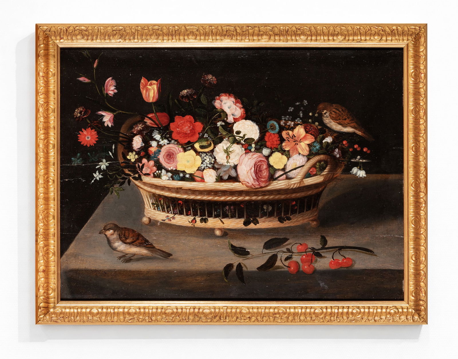 JAN BRUEGHEL THE YOUNGER (Antwerp, 1601 – 1678), attributed - Basket of Flowers with Birds: Oil on parquet panel. Dimensions: 49 x 64 cm. Presented in a decorative gilt frame. The composition is set on a light stone slab against a dark background, where a large wicker basket with visible han