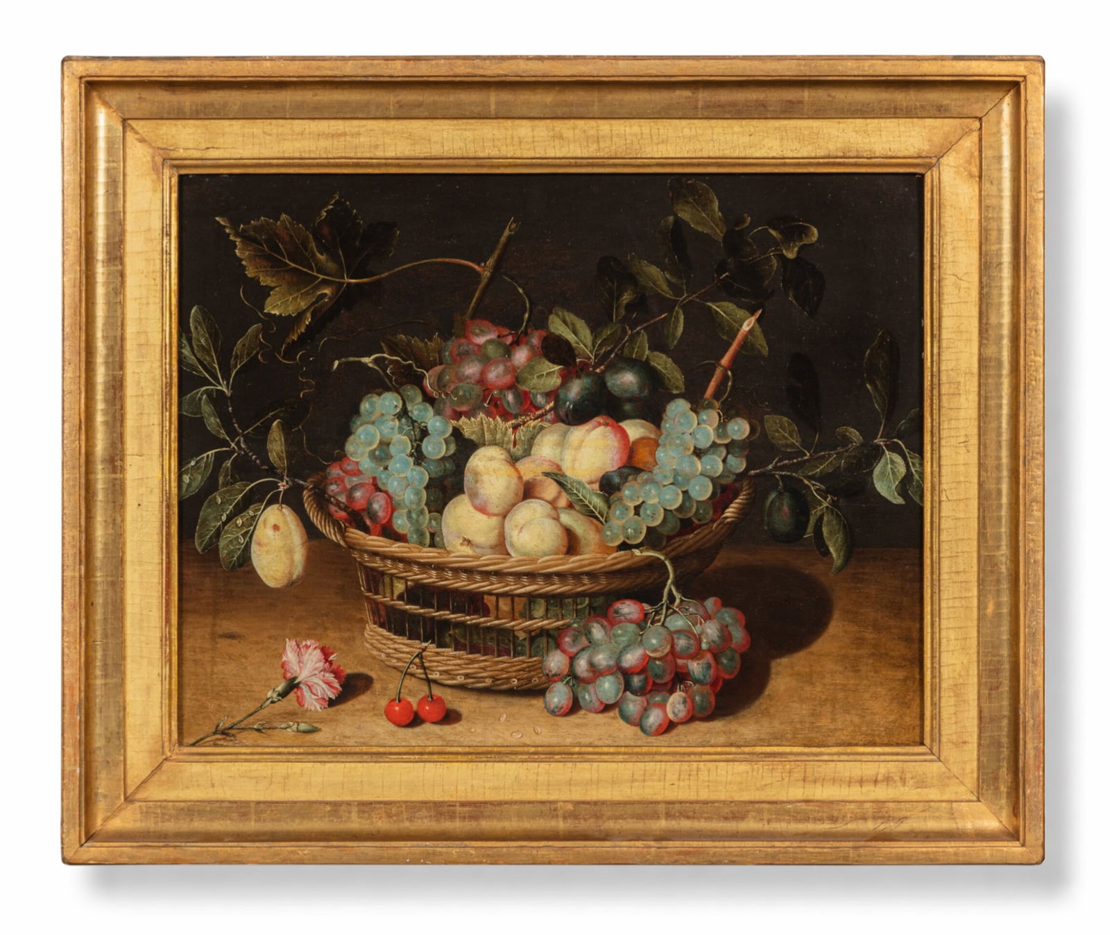 ISAAK SOREAU (Hanau, 1604 – after 1645, ibidem) - Still Life with Basket of Fruit and Carnation: Oil on panel. Dimensions: 47 x 63 cm. We thank Dr. Fred G. Meijer for confirming the attribution to the aforementioned artist. On a table partially in shadow, in the center of the composition, sits a