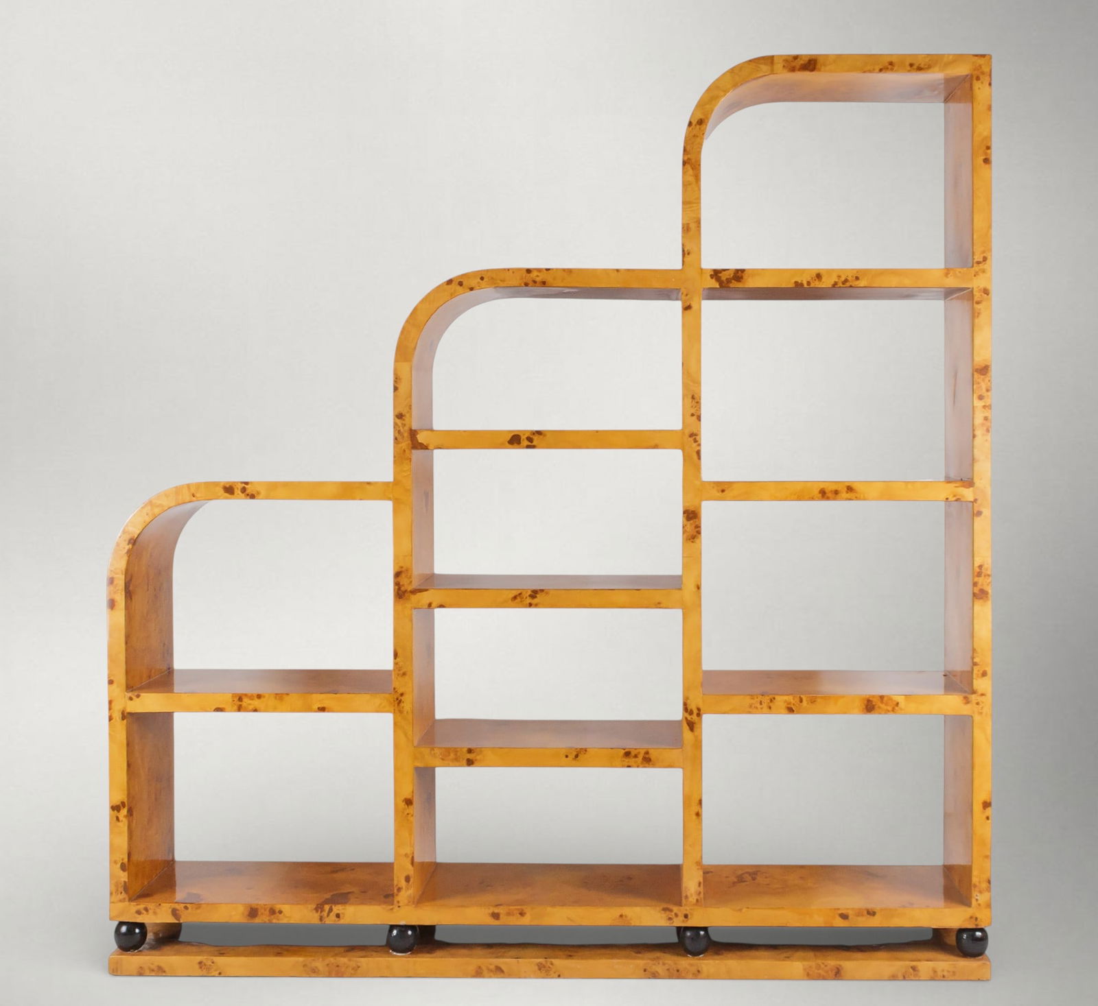 Tiered bookcase. Art Deco style. 20th century: Wood with an elm finish and ebonized details. Dimensions: 169 x 161 x 29 cm. This shelving unit features a distinctive stepped design, conceived through an asymmetrical geometric composition that orga