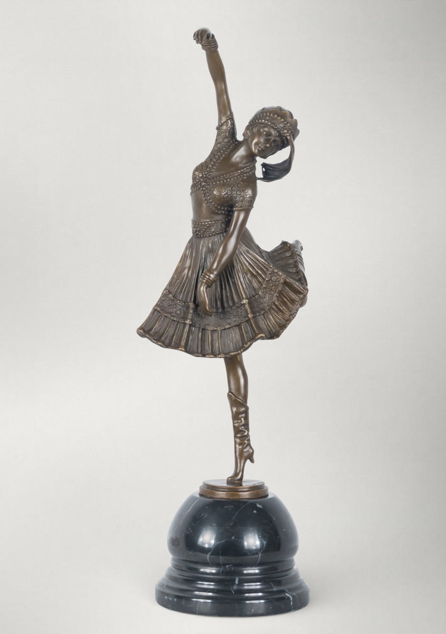 Cossack Dancer, After Dimitri Chiparus, Art Deco, 20th Century, Signed: Patinated bronze on a marble base, cast and chased. Dimensions: 55 x 20 x 15 cm. Sculpture of a female figure captured in a dynamic dance motion, with a stylized body in an elegant twist, one arm rais