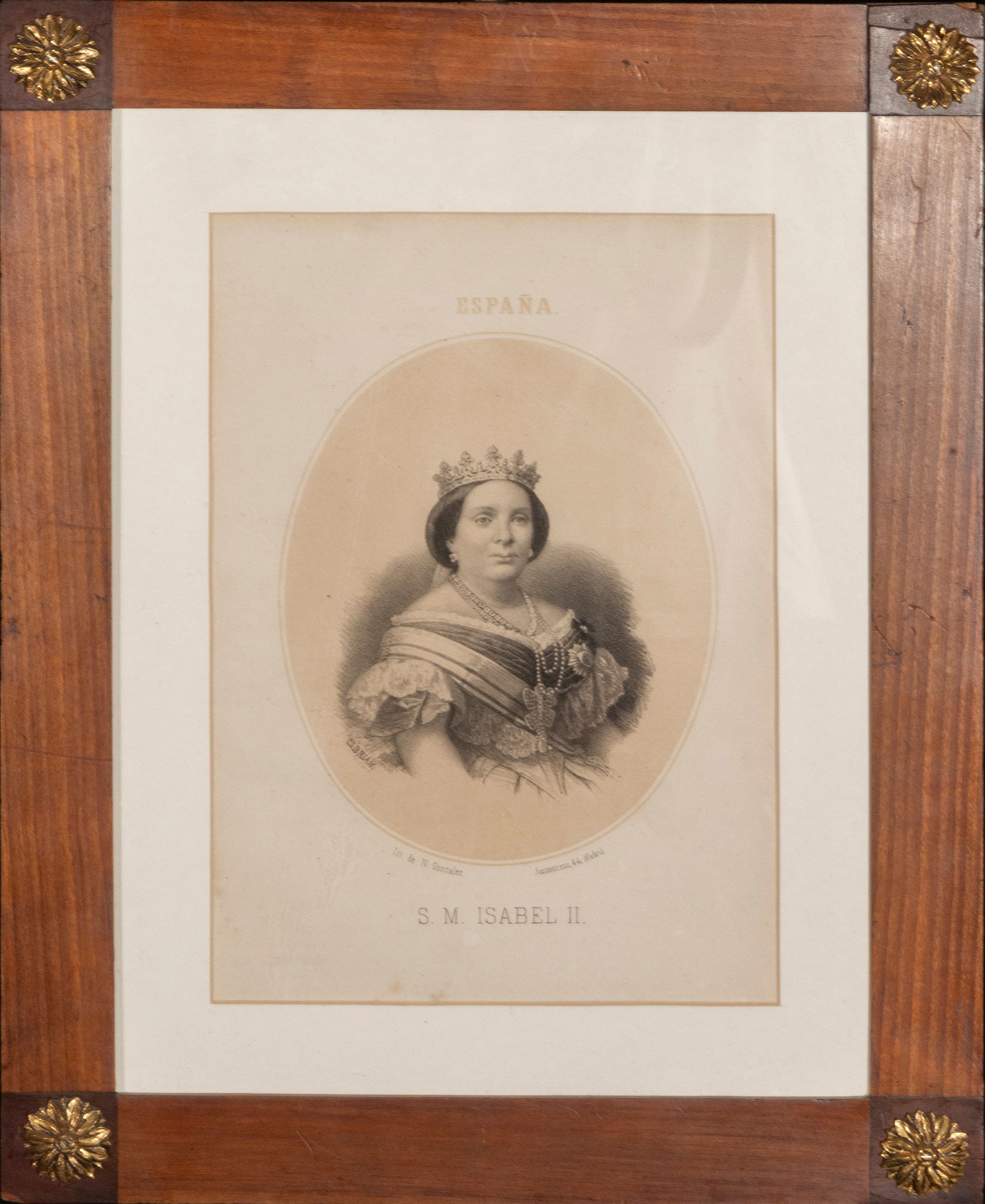 Portrait of Isabella II, Spanish School, 19th Century: Engraving on paper. Measures 27 x 19 cm and 42 x 33 cm with frame. Bust portrait of Isabella II, presented within an oval and crowned with royal symbols, with a serene and frontal depiction that under
