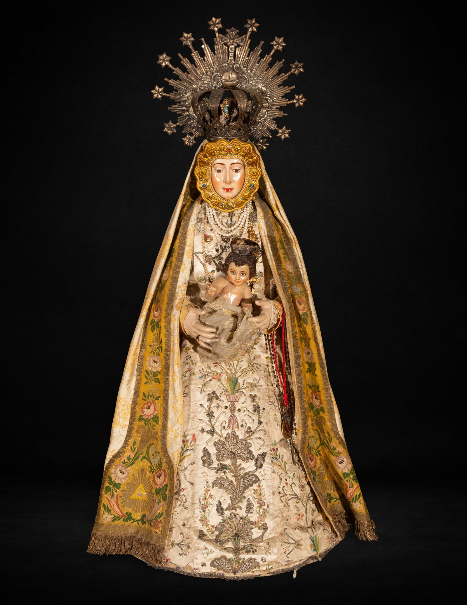 Dressed Virgin with Child. 20th Century: Polychrome wood carving for dressing. Measures 141 x 60 x 60 cm. The Virgin holds the Child in her arms, creating a balanced, frontal composition where divine motherhood becomes the visual focus. The