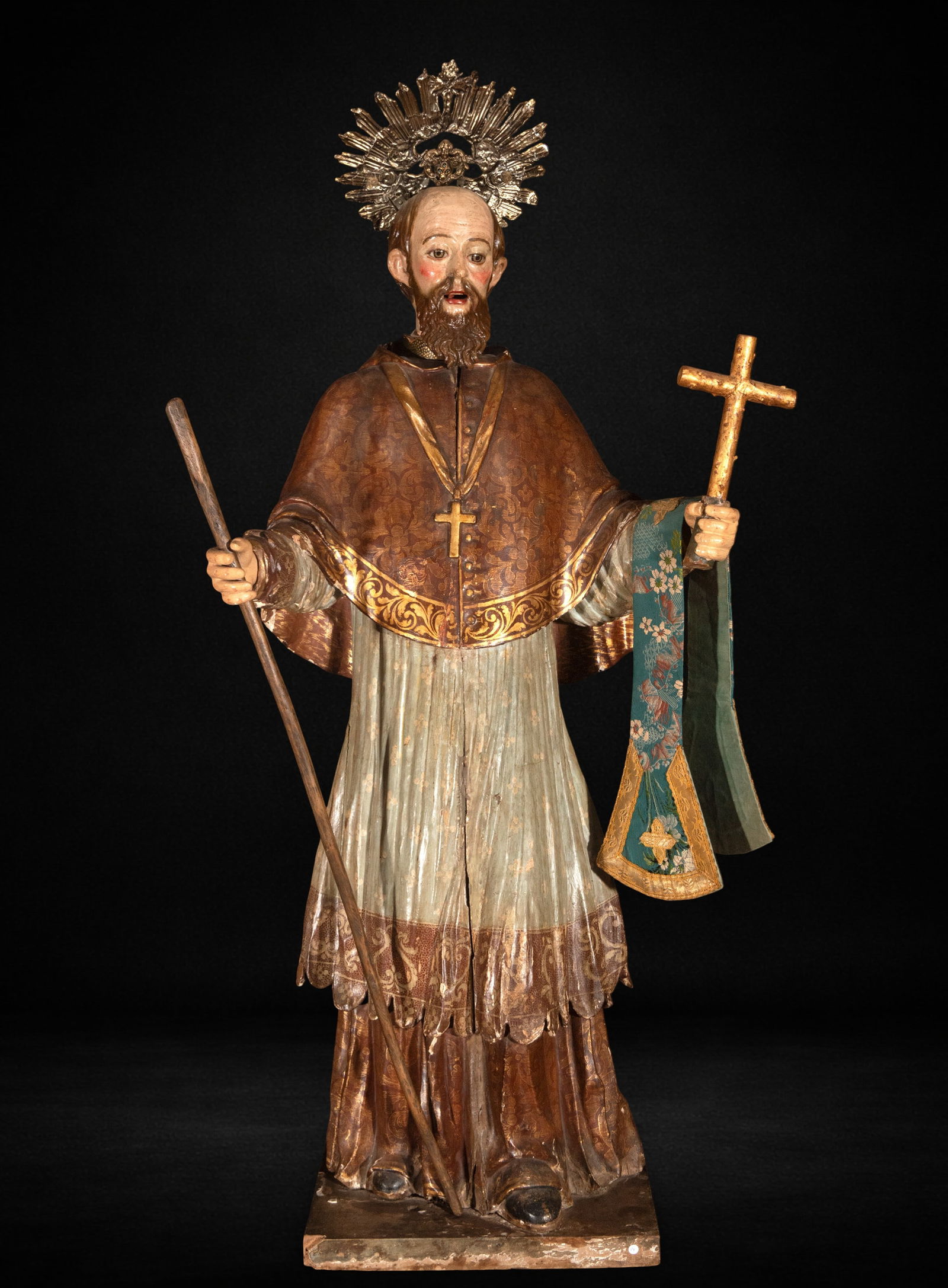 San Francisco Javier, Mexico - Colonial, 18th Century: Carved and polychromed wood. Measures 110 x 52 x 28 cm. Image of Saint Francis Xavier depicted standing, wearing a habit and decorated cloak, holding a cross in his right hand and a staff in his left,