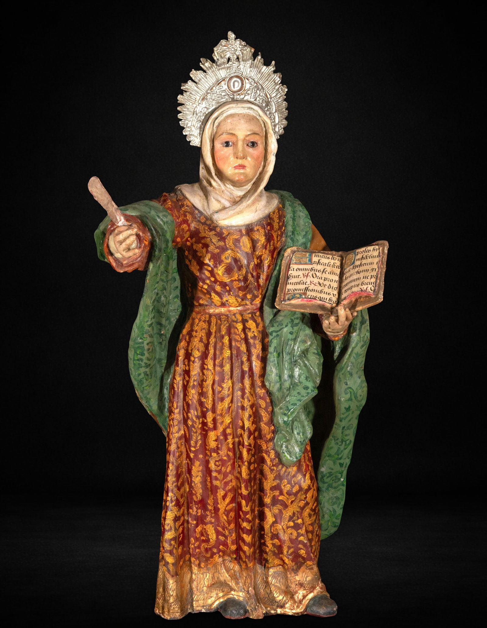 Saint Anne, 18th Century: Carved and polychromed wood. Measures 67 x 34 x 15 cm. Image of Saint Anne standing, depicted with solemn frontality and a subtle dynamism in the gesture of her outstretched right arm, while in her le