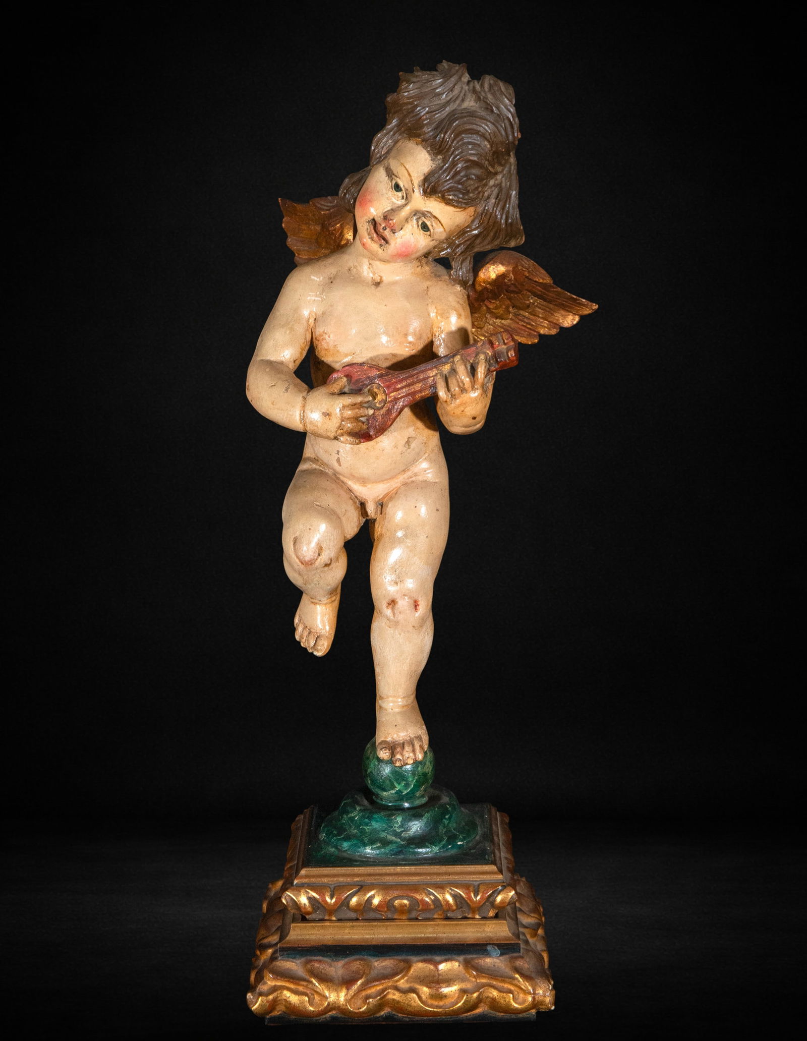 Angel, musician, mid-20th century: Carved and polychromed wood. Measures 60 x 20 x 23 cm. Winged musical angel holding an instrument, decorative composition from the mid-20th century.