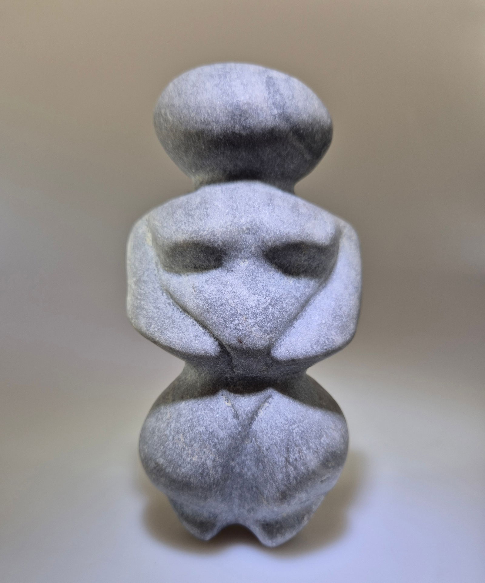 Neolithic steatopygous female figure in marble (Mother Goddess), Mediterranean Region /: Matte black-gray marble with small veins and inclusions. Neolithic female idol of the steatopygeous type (“Mother Goddess”), with pronounced volumetric forms associated with fertility, arms fo