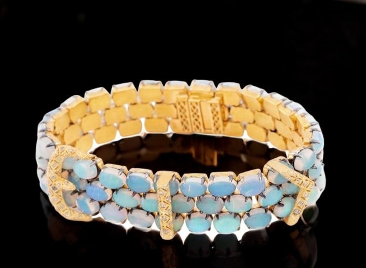 Opal and diamond bracelet: This bracelet, crafted from 925 sterling silver with a gilt finish, features a series of opals set and enhanced by a row of rose-cut diamonds at the top. It contains approximately seventy-five opals w