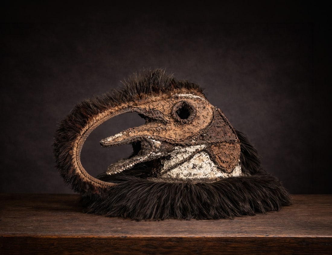 Elema Cassowary Mask from Papua Ritual Dance, Oceania. 20th century: Depicting a cassowary. Braided plant material, clay pigments, cassowary feathers. Provenance - Ricardo Ostalé Collection - Collected in the field by George J. Craig (Peru 1930 - Australia 2024). Dime