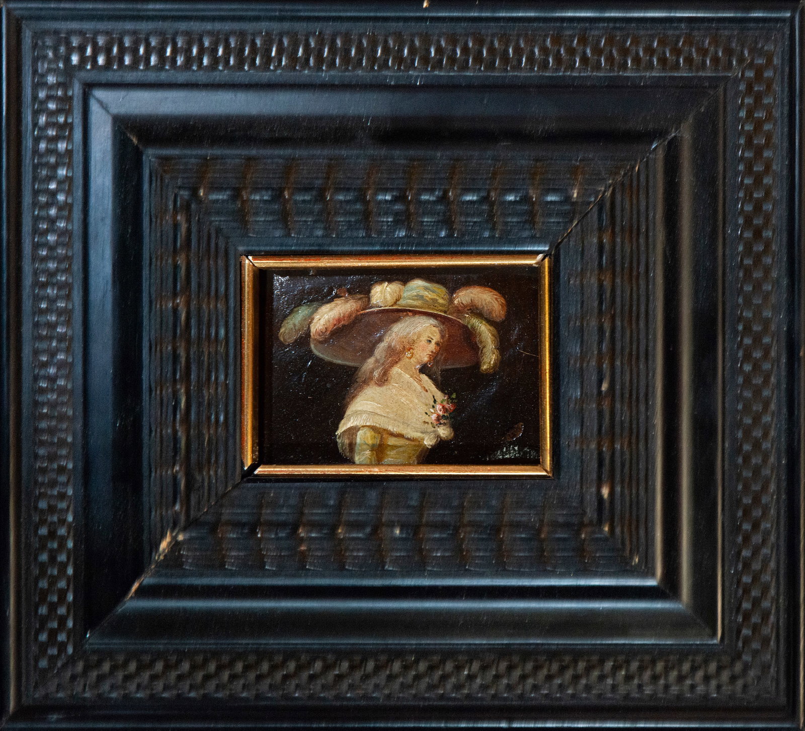 Female portrait with hat, Spanish school, 19th century: Oil on panel or metal. Dimensions 10 x 7 cm; framed 22 x 24 cm. A small bust portrait of a young woman, conceived with a refined miniature spirit, depicts her in profile, slightly turned, wearing a wi