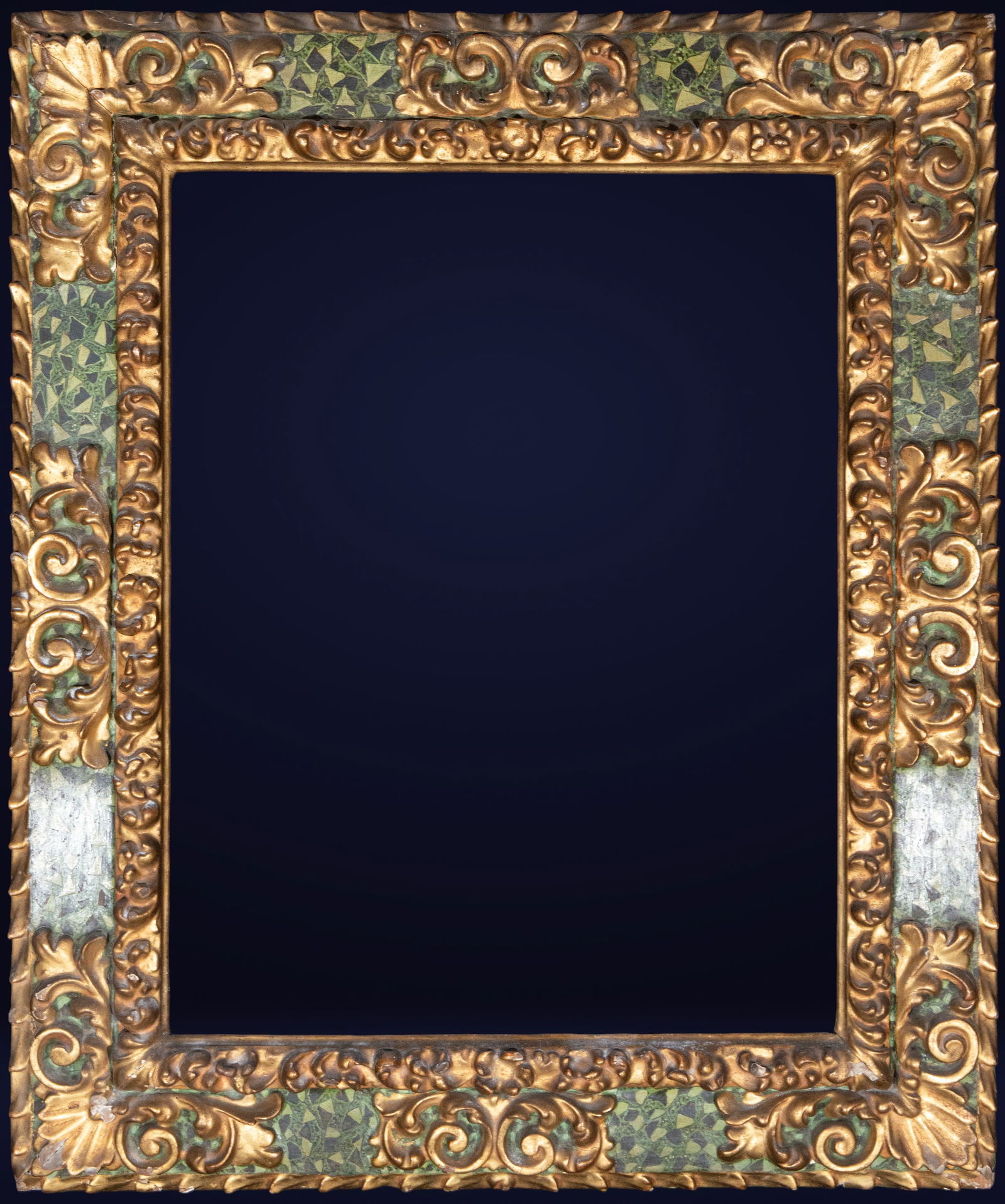 Marbled Baroque frame, Spanish school, 18th century: Gilded wood, polychromed to resemble green marble. Dimensions: 75 x 58 cm; 104 x 85 cm. The frame is remarkably ornate, with a molded structure and Baroque decoration of scrolls, fleshy leaves, and gi
