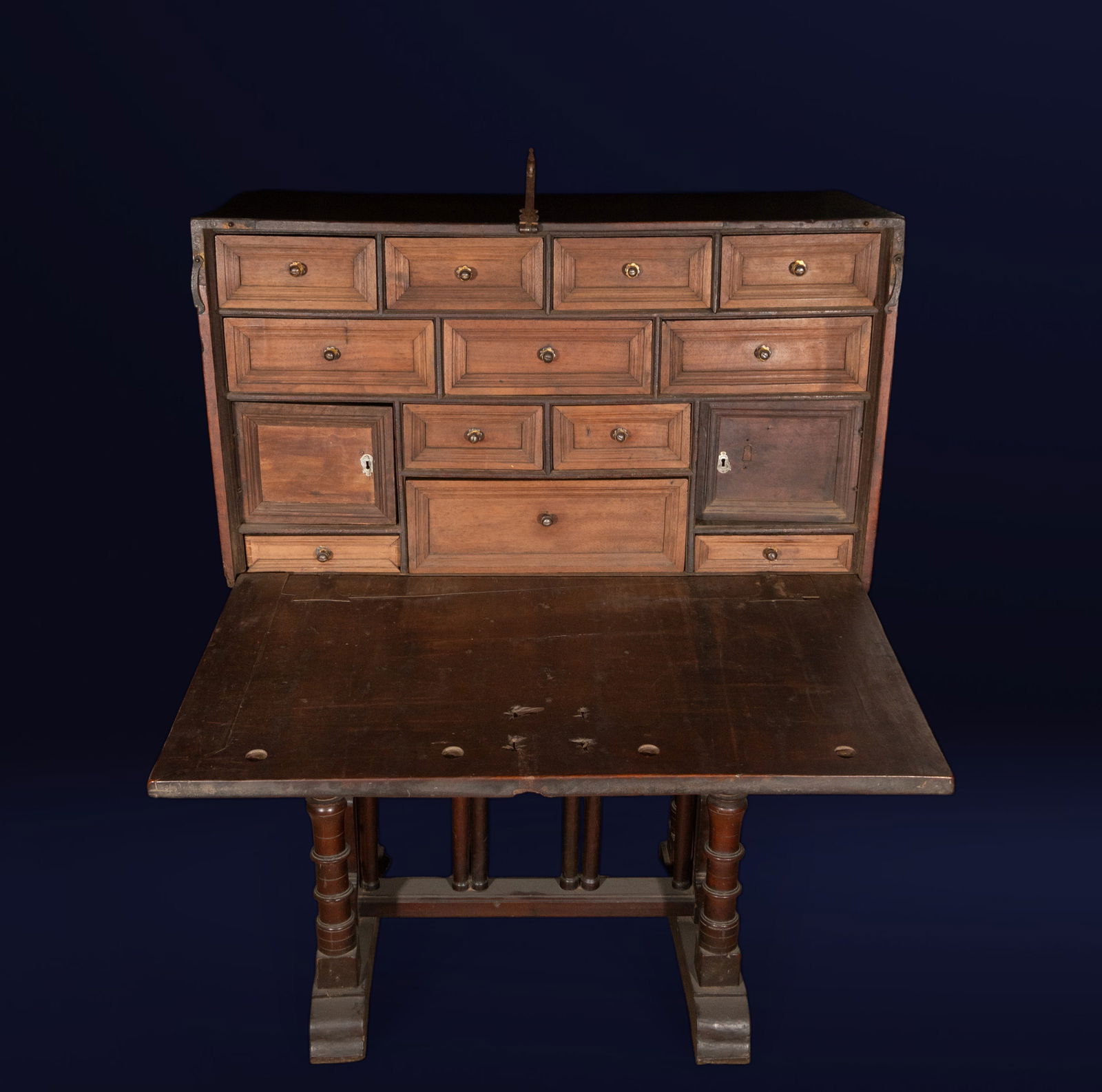 Bargueño, Spanish school, 18th century: Walnut and metal fittings. Dimensions: Headboard 52 x 93 x 40 cm; Overall: 129 x 93 x 52 cm. A bargueño (a type of writing desk) with an architectural front, a hinged lid, and an interior organized w