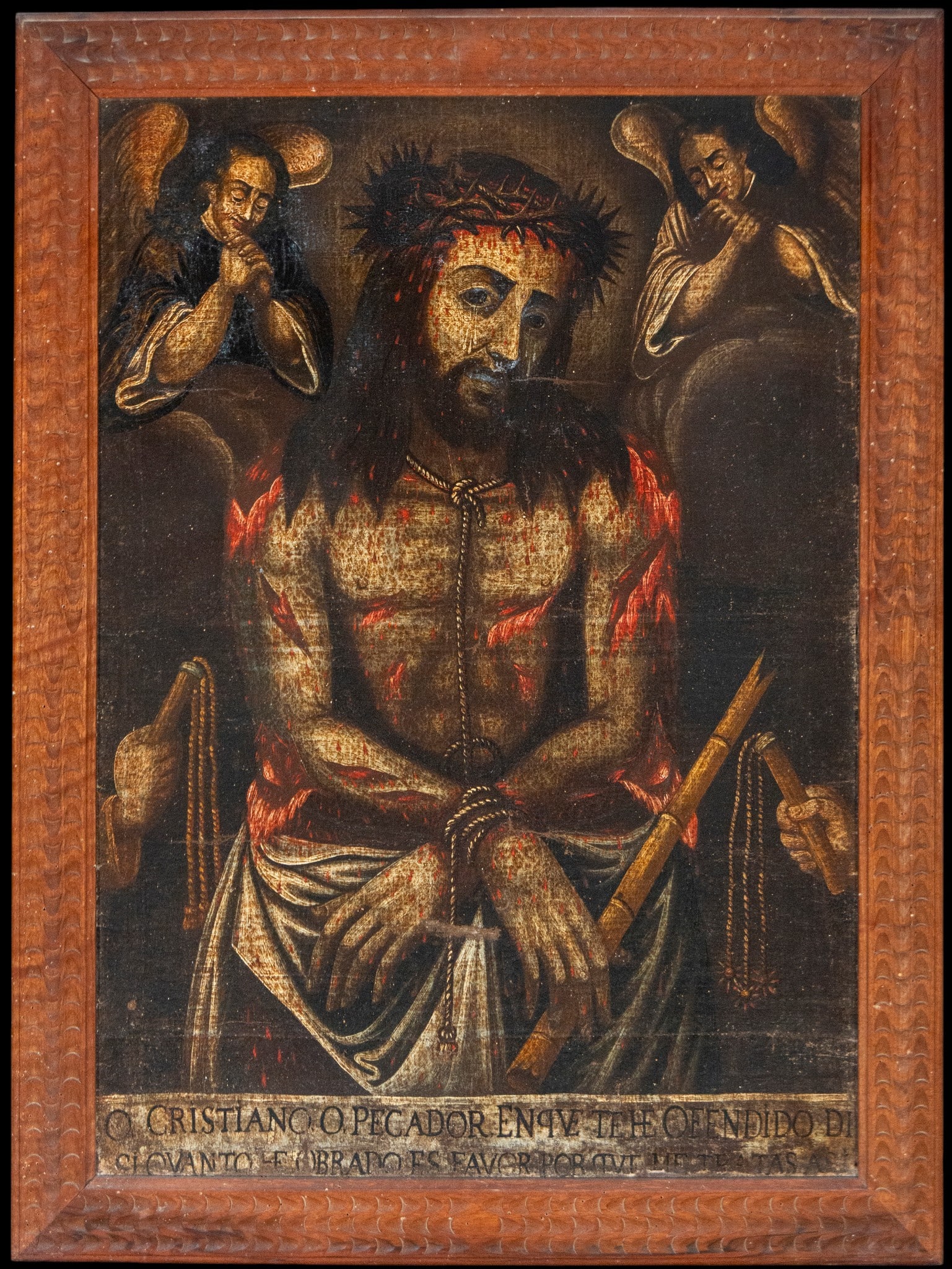 Christ of Sorrows, Mexican Colonial School, 18th Century: Oil on canvas. Dimensions: 85 × 62 cm / 98 × 75 cm. Frontal image of the sorrowful Christ, crowned with thorns and seated, accompanied by angels in prayer and an exhortative inscription at the botto
