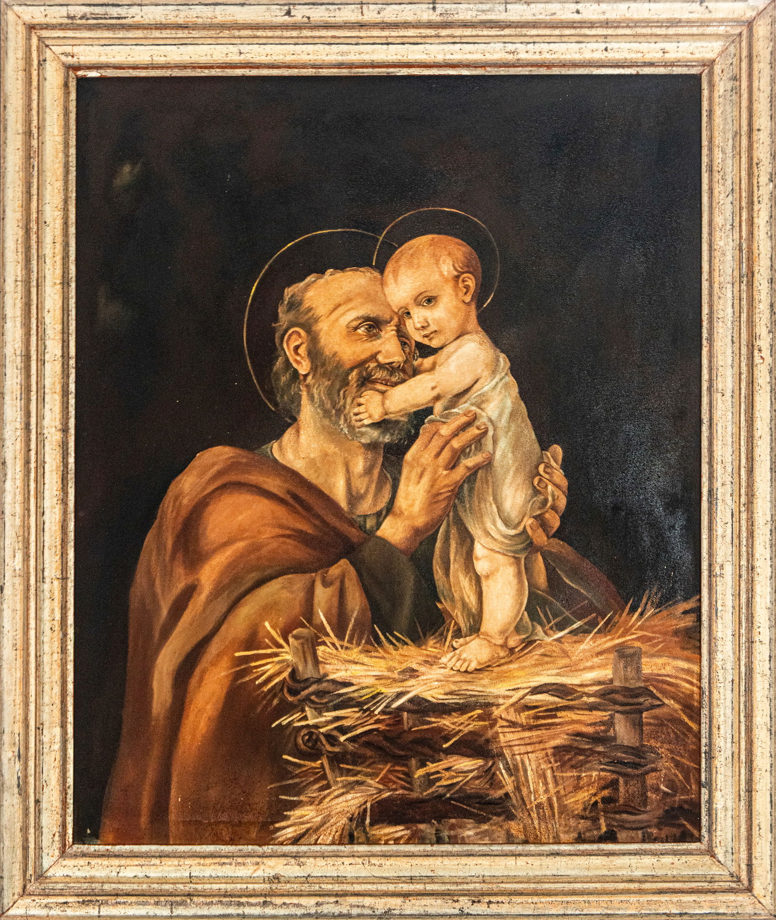 Saint Joseph with the Child, Spanish school, 19th century: Oil on canvas. Dimensions 93 x 78 / 112 x 96 cm. Devotional image of Saint Joseph holding the Christ Child on a bed of straw, in a close and intimate pose that emphasizes the tenderness of their bond