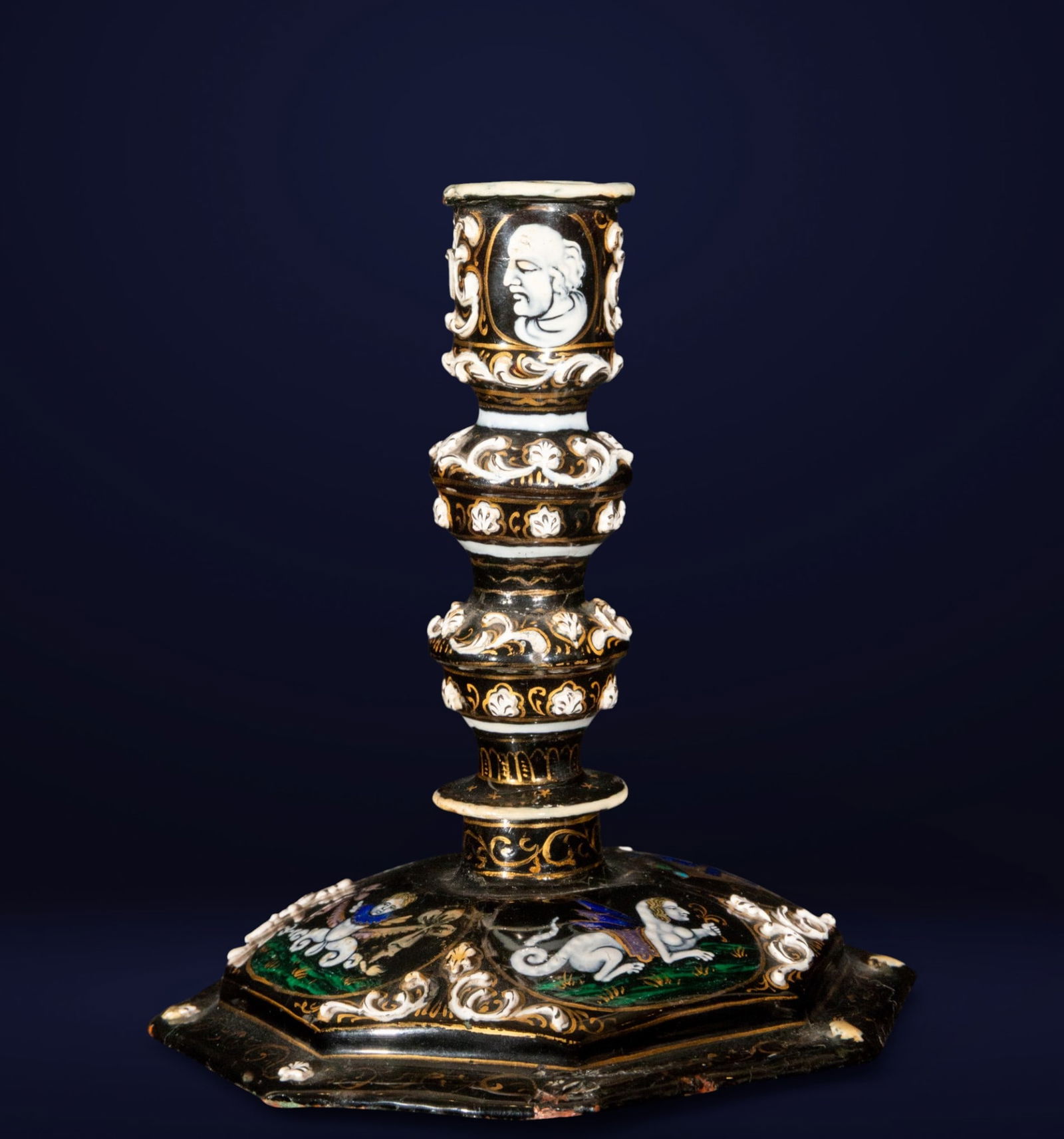Exceptional Limoges enamel candelabra from the end of the 17th century: Limoges enamel. Measures 15 x 13 x 13 cm. A candlestick with a turned profile and polygonal base, enriched with enamel decoration in black, white, blue, green, and gold, featuring alternating scrolls,