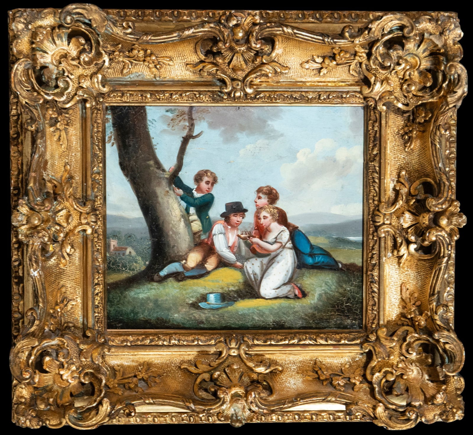 Children's game. French school. 19th century: Oil on tin. Dimensions 19 x 22 / 31 x 34 cm. A charming and childlike outdoor scene depicts several children gathered by a tree, playing and conversing within a gentle, open landscape. The composition