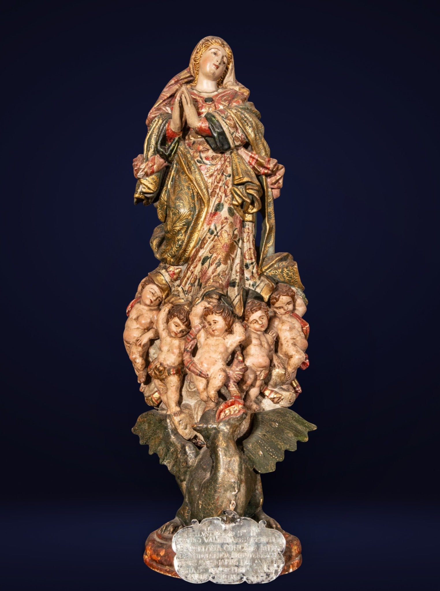 Immaculate Conception, Hispanic American School, 18th Century: Carved, polychromed, and gilded wood. Measures 56 x 22 x 19 cm. With a silver indulgence from the Bishop of Barcelona dated 1783.