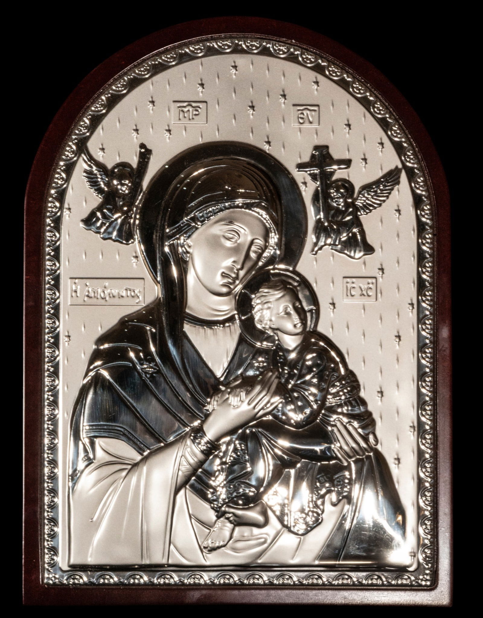 Icon of the Virgin and Child, Greek Orthodox School, 20th Century, with seal: Repoussé silver on a wooden support. Measures 30 x 21 cm and 34 x 23 cm. Icon of the Virgin and Child in the Orthodox tradition, made with a silver relief plaque on a wooden support, with a dotted ba