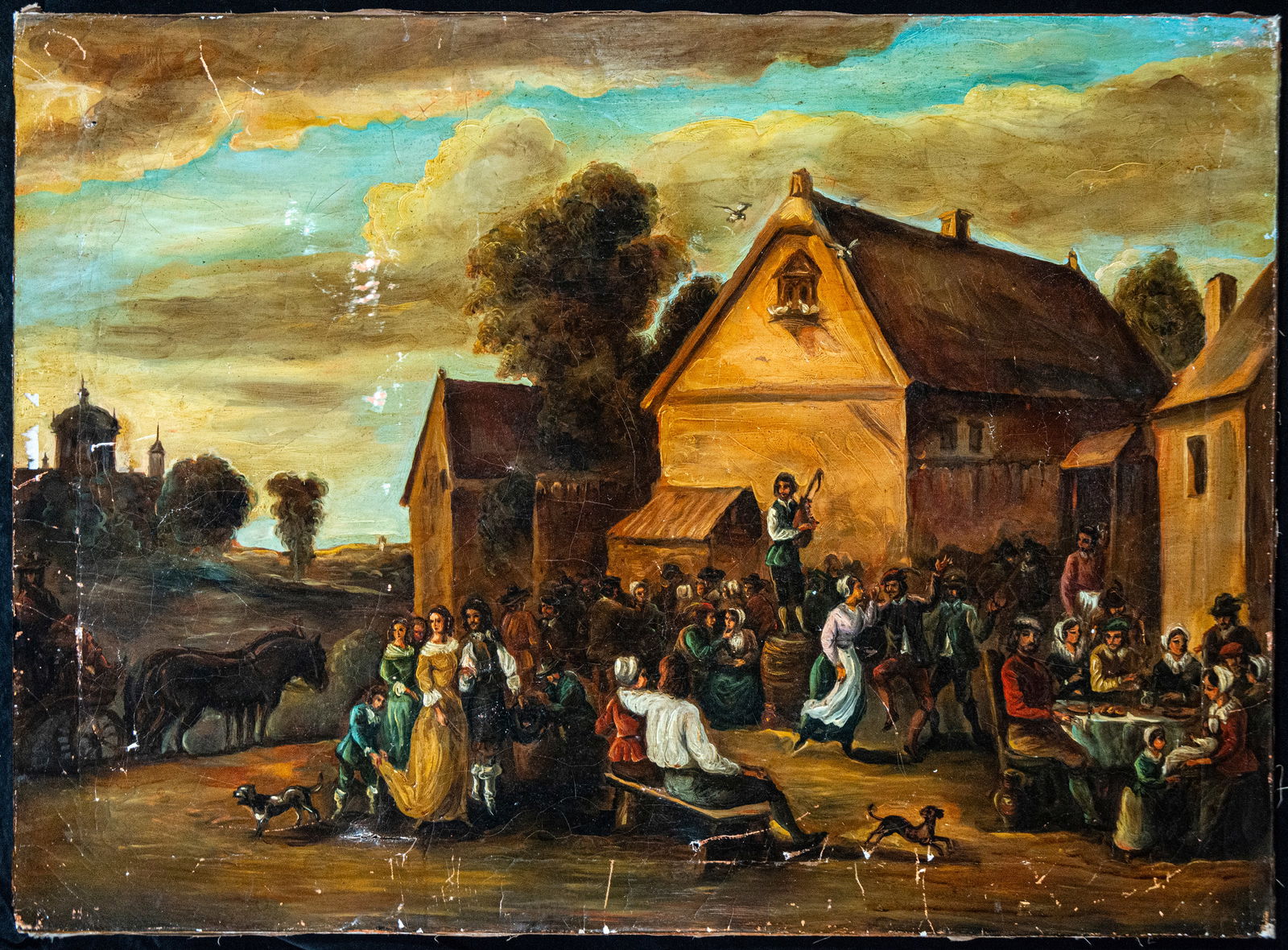 Popular village scene, Flemish school, 17th century: Oil on canvas. Dimensions 100 x 70 cm. A lively village scene with numerous figures gathered before several buildings with sloping roofs, featuring musicians, dancers, diners, and figures in conversat