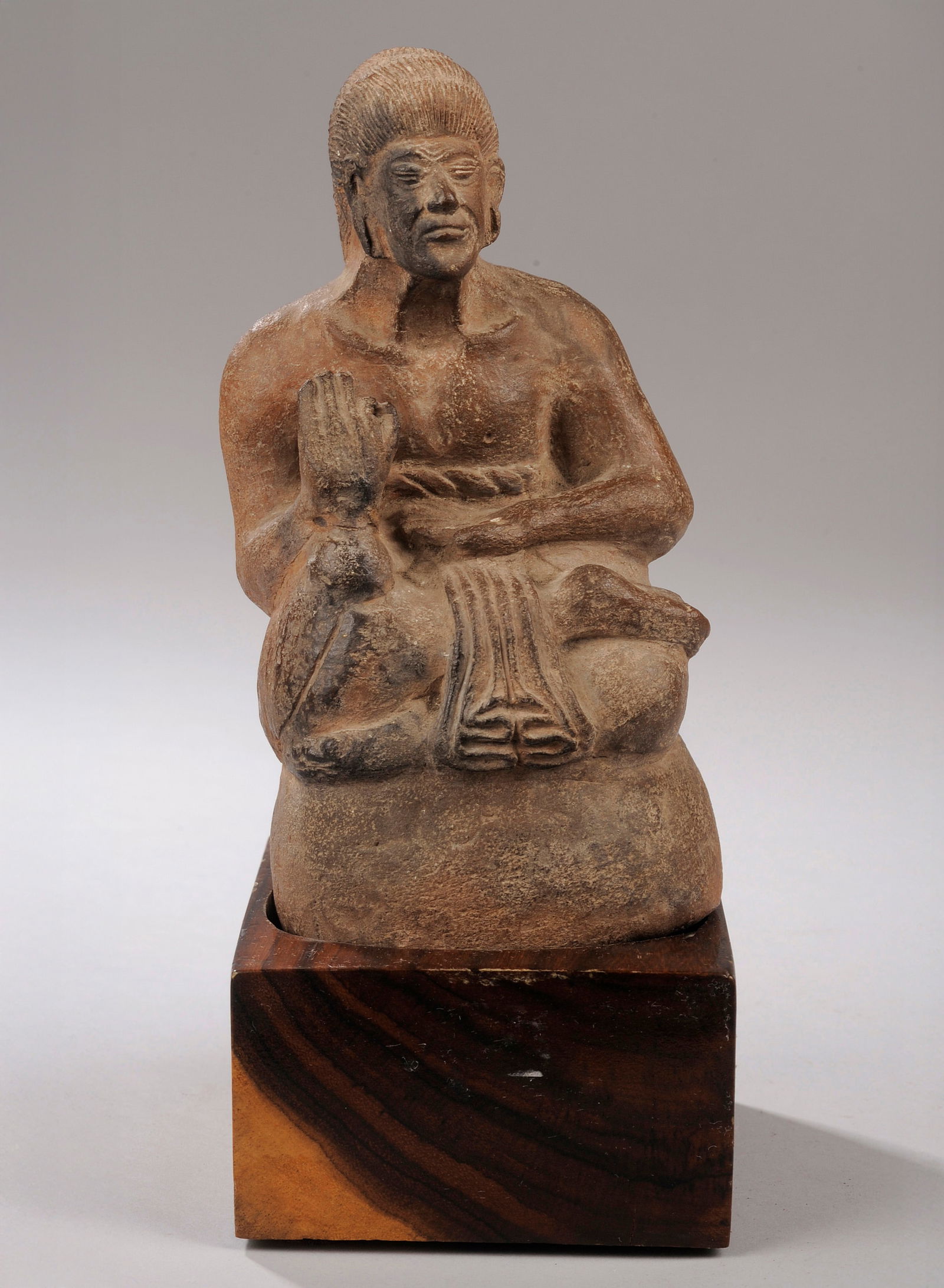 Figure of a seated shaman carrying a kriss on his back. Terracotta. Majapahit Kingdom. East Java, (1 of 1)