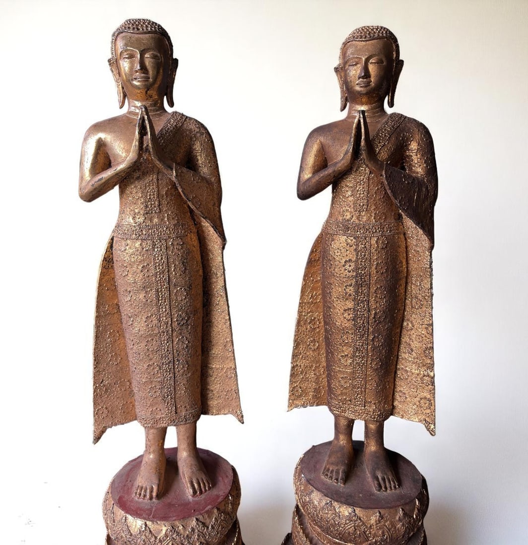 A pair of important Buddhist temple worshippers. Thailand. Rattanakosin Kingdom. 19th century.: A pair of important worshippers standing on a high, stepped circular mound in a hieratic posture, their hands clasped in anjlai mudra, and dressed in monastic robes richly embroidered with floral moti