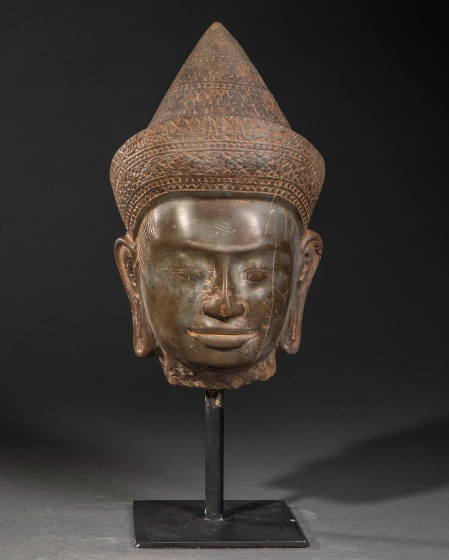 Head of Vishnu with a conical tiara and ornate diadem. Polished stone. Cambodia/Khmer. Baphuon. 13th (1 of 3)