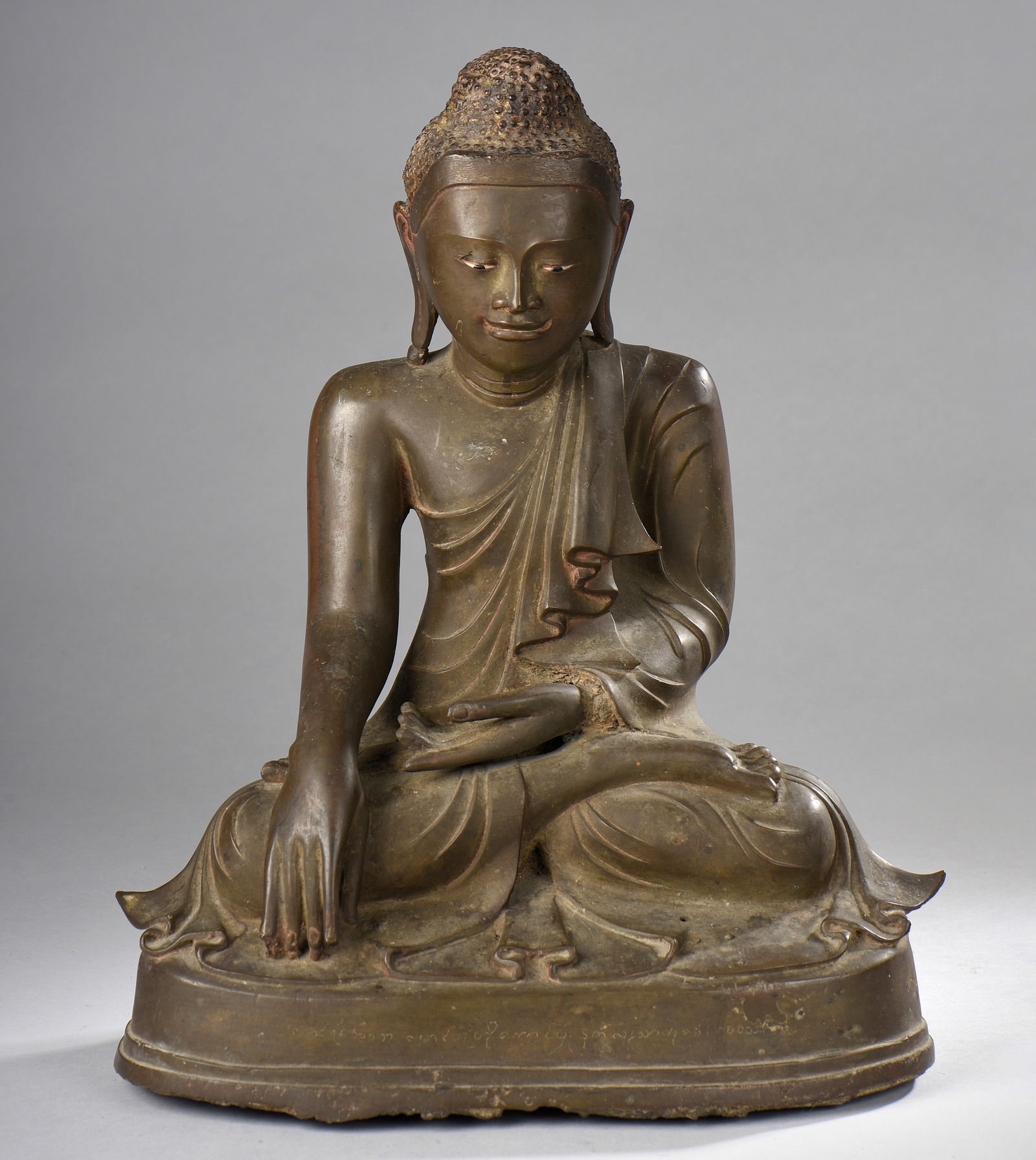 Buddha Marawijaya, seated in dhyanasana, wearing a pleated monastic robe, touches the earth with his (1 of 1)