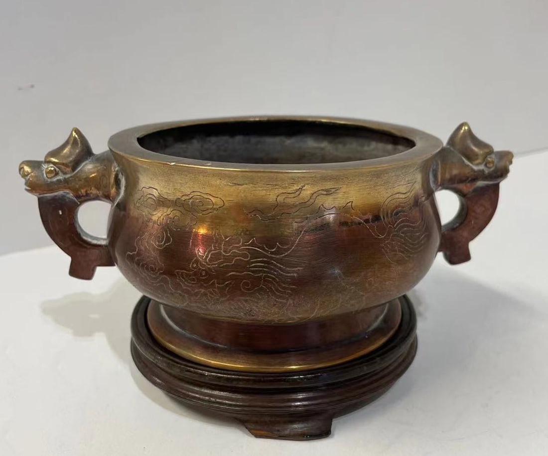 Large Chinese Qing Imperial Bronze Incense Burner - China - Qing Dynasty: Large, flat-bodied incense burner with two zoomorphic handles featuring chimera heads and a dragon incision. Mark on the base, molded with an interlacing of imperial dragons. Bronze. China. Qing Dynas