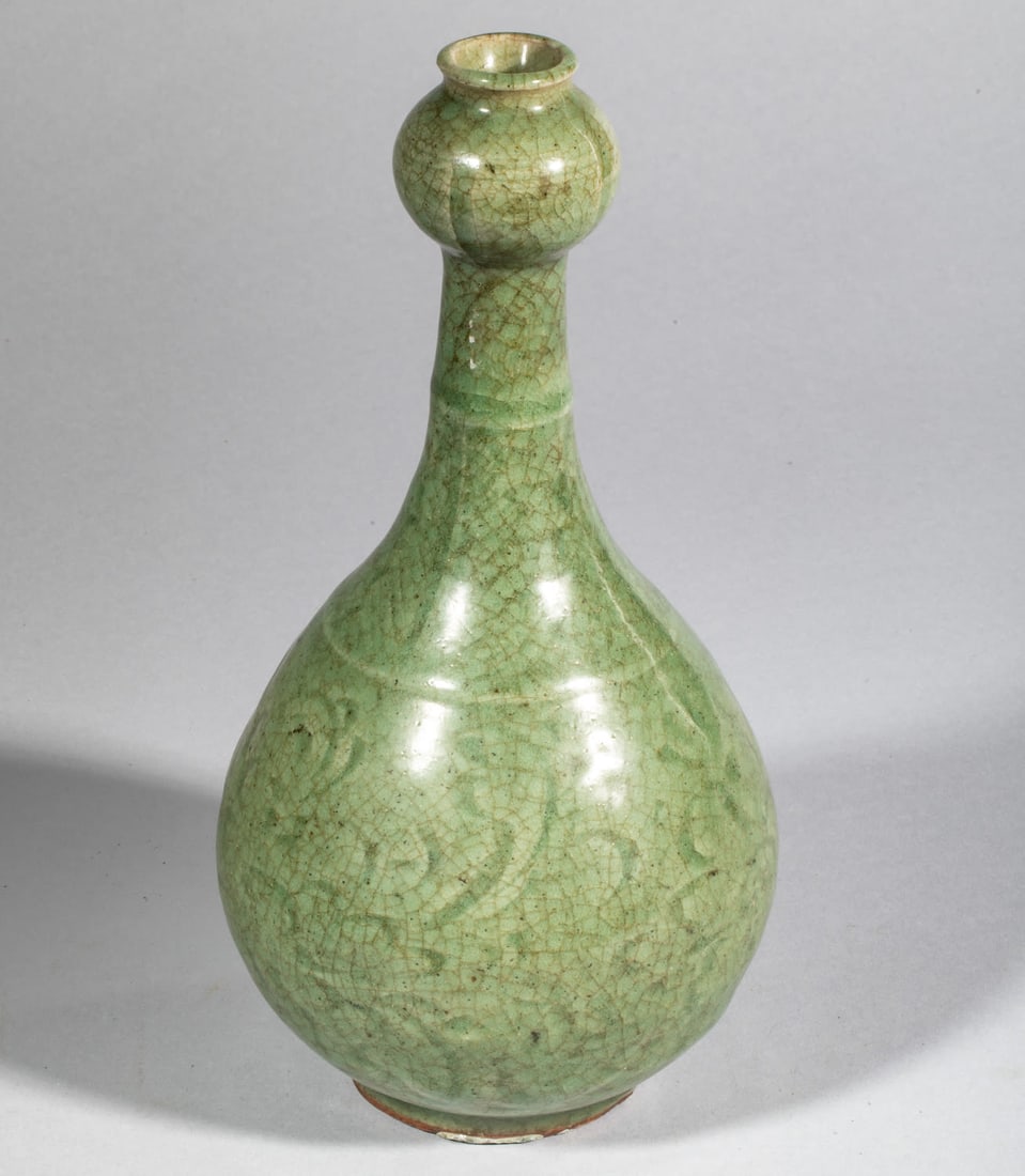A bottle with a globular body at the top of the stem and a tall, bulbous neck at the end, made of (1 of 10)
