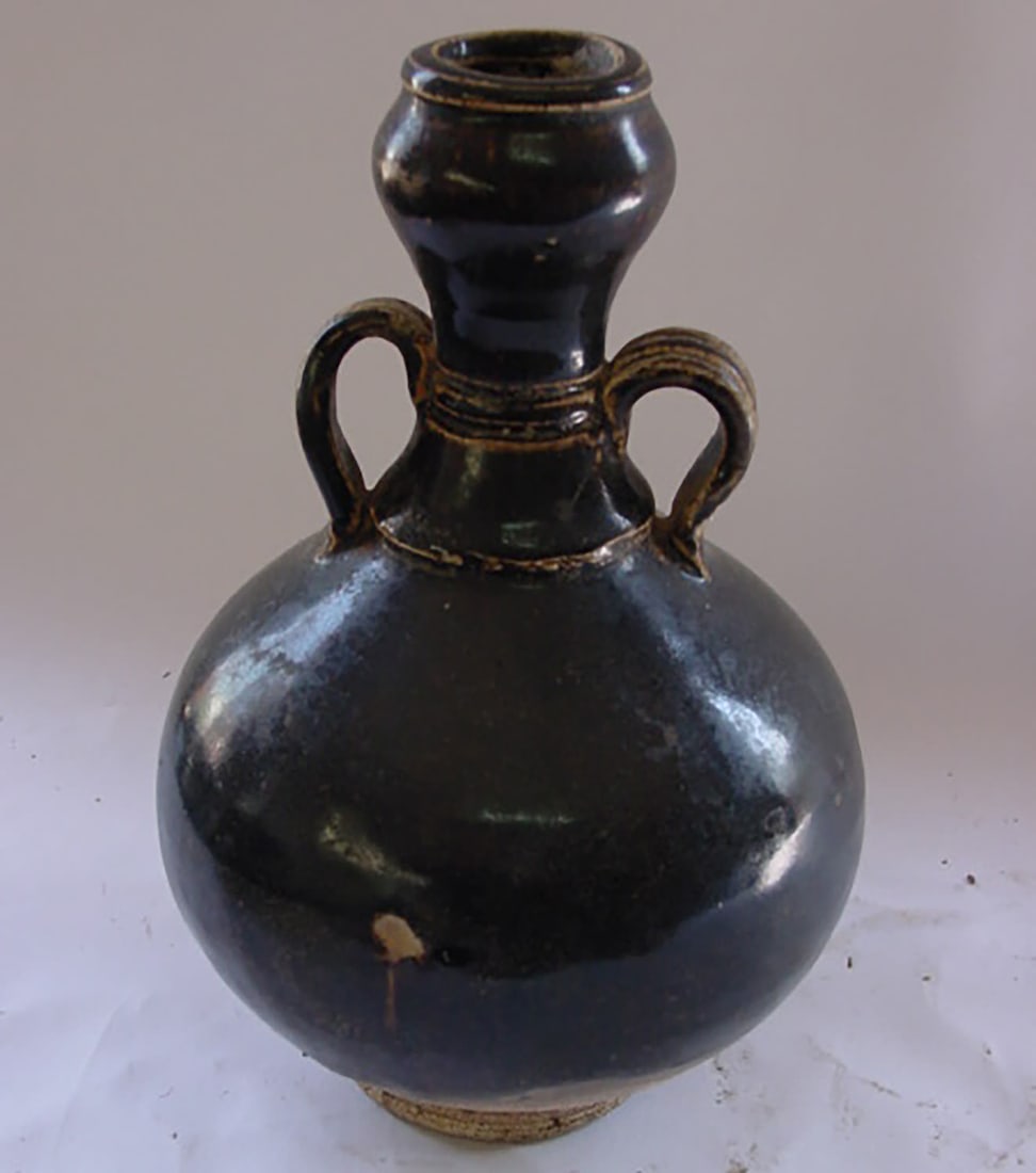 A pot-bellied bottle with a tall, bulbous neck set with two large handles in porcelain stoneware: Jin Dynasty. 1115 to 1234. Height 20 cm x diameter 3.5 cm. Stove gloss. China - Tibet - Ming - Qing - Oriental Art - Asian Art - Chinese Art. Provenance: Property of an important private collection, a