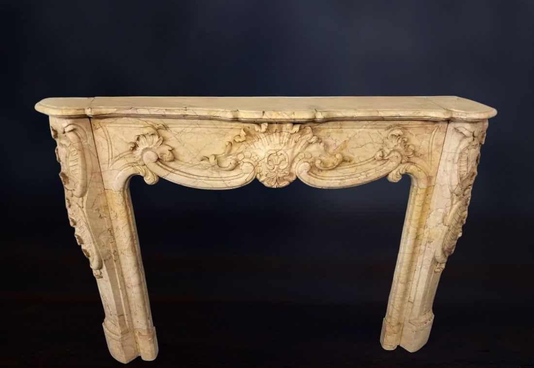 Crema Valencia marble fireplace, Italy, 20th century: Carved Crema Valencia marble. Dimensions: exterior 164 × 114 × 34 cm; interior 120 × 86 cm. An elegant and refined fireplace with balanced proportions, crafted from a highly luminous marble with ex