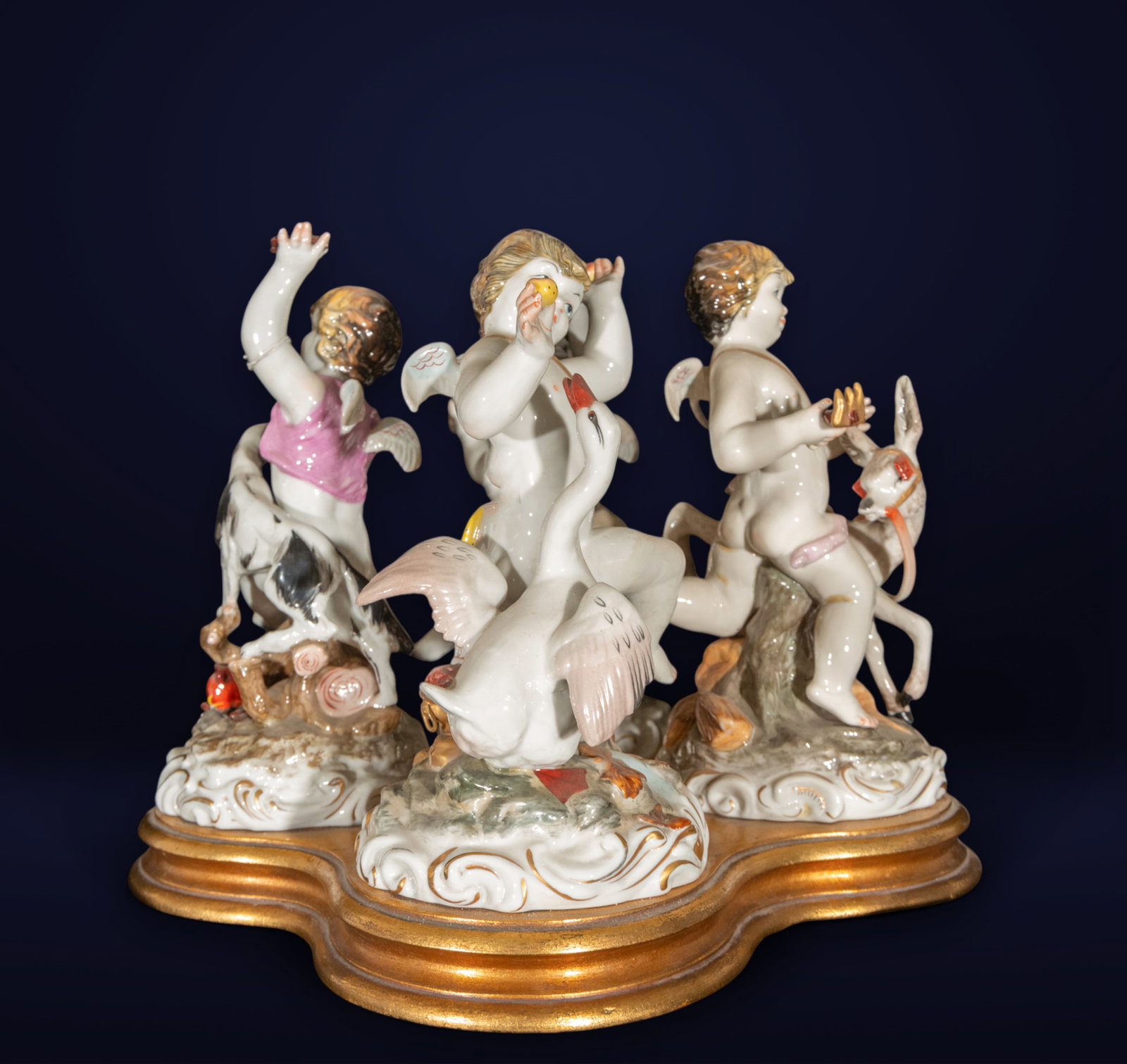Sculptural group from Algora with four little angels with different animals: Polychrome Algora ceramic. A charming sculptural composition depicting four cherubs interacting with various animals, including swans and goats, in a dynamic and expressive ensemble. Each figure is ri