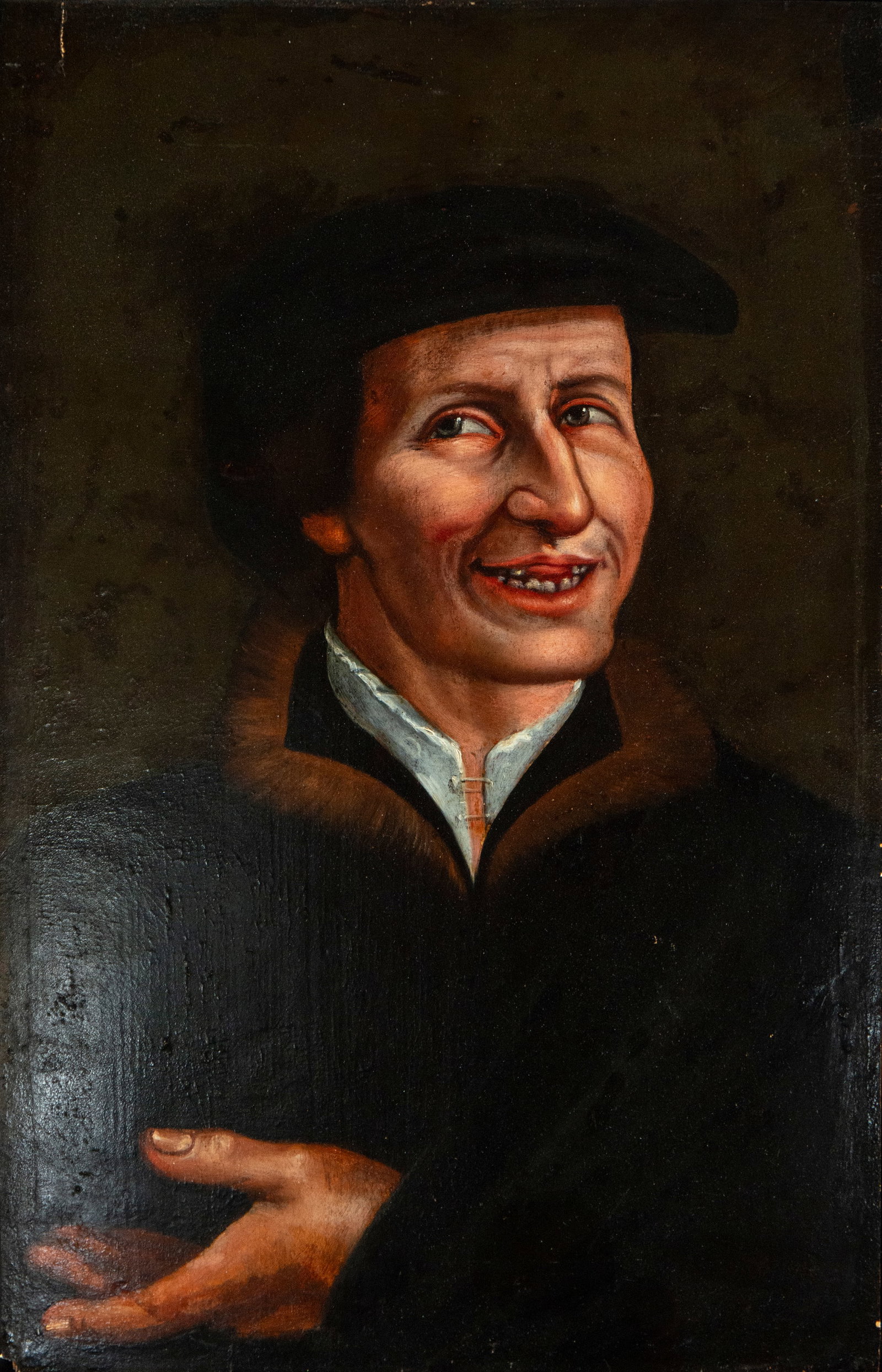 Portrait of a Gentleman. Dutch School. 17th Century.: Oil on panel. This half-length portrait shows a smiling gentleman, wearing a fur cape and a black cap, in a gestural attitude that suggests eloquence or courtesy. The dark background and the lighting